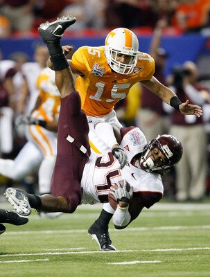 ATLANTA - DECEMBER 31:  Running back Ryan Williams #34 of the Virginia Tech Hokies is tripped up as defensive back Janzen Jackson #15 of the Tennessee Volunteers pursues him during the Chick-Fil-A Bowl at the Georgia Dome on December 31, 2009 in Atlanta, 