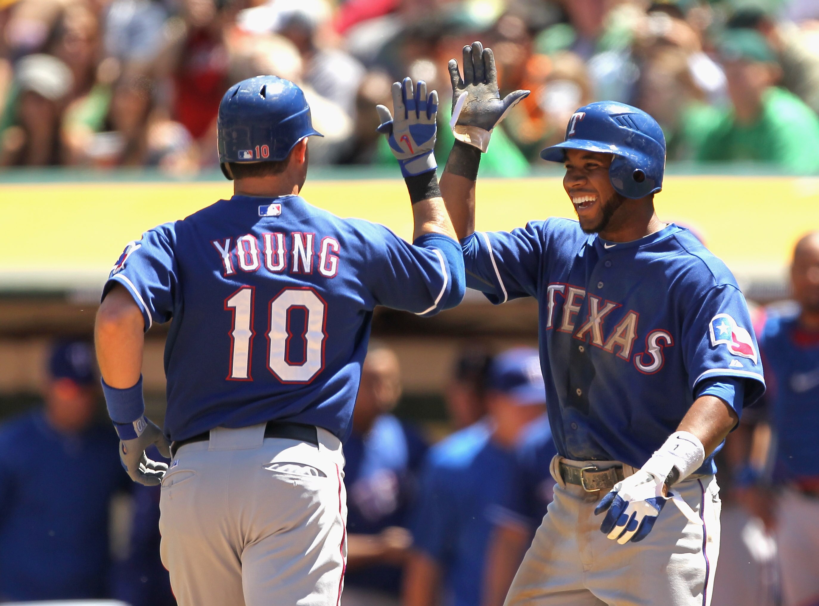 OAKLAND, CA - APRIL 30:  Michael Young #10 of the Texas Rangers is congratulated by Elvis Andrus #1 of the Texas Rangers after Young hit a home run against the Oakland Athletics at Oakland-Alameda County Coliseum on April 30, 2011 in Oakland, California.