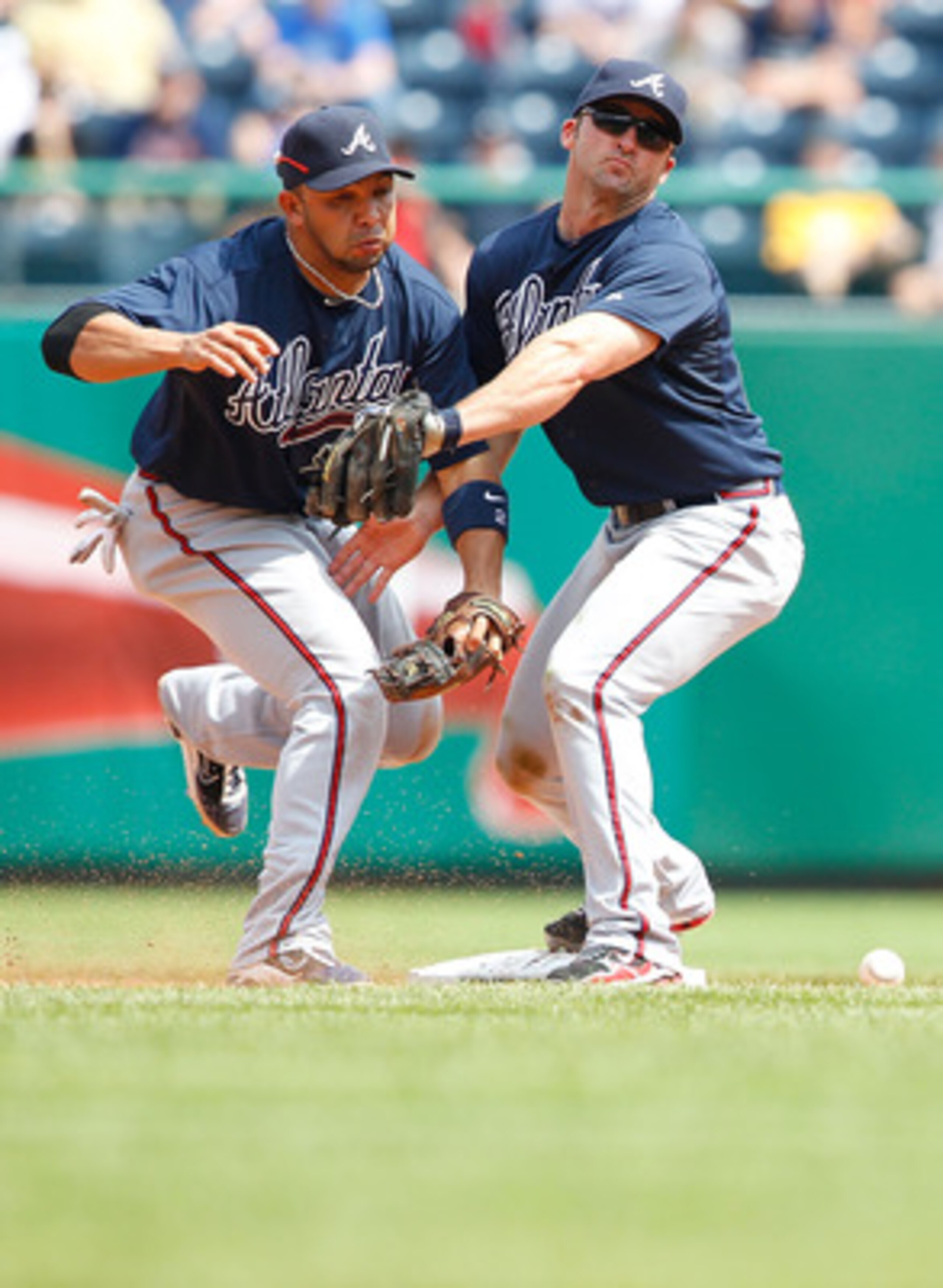 PITTSBURGH - MAY 25:  Alex Gonzalez #2 and Dan Uggla #26 of the Atlanta Braves collide when trying to both make a play at second base during the game against the Pittsburgh Pirates on May 25, 2011 at PNC Park in Pittsburgh, Pennsylvania.  (Photo by Jared