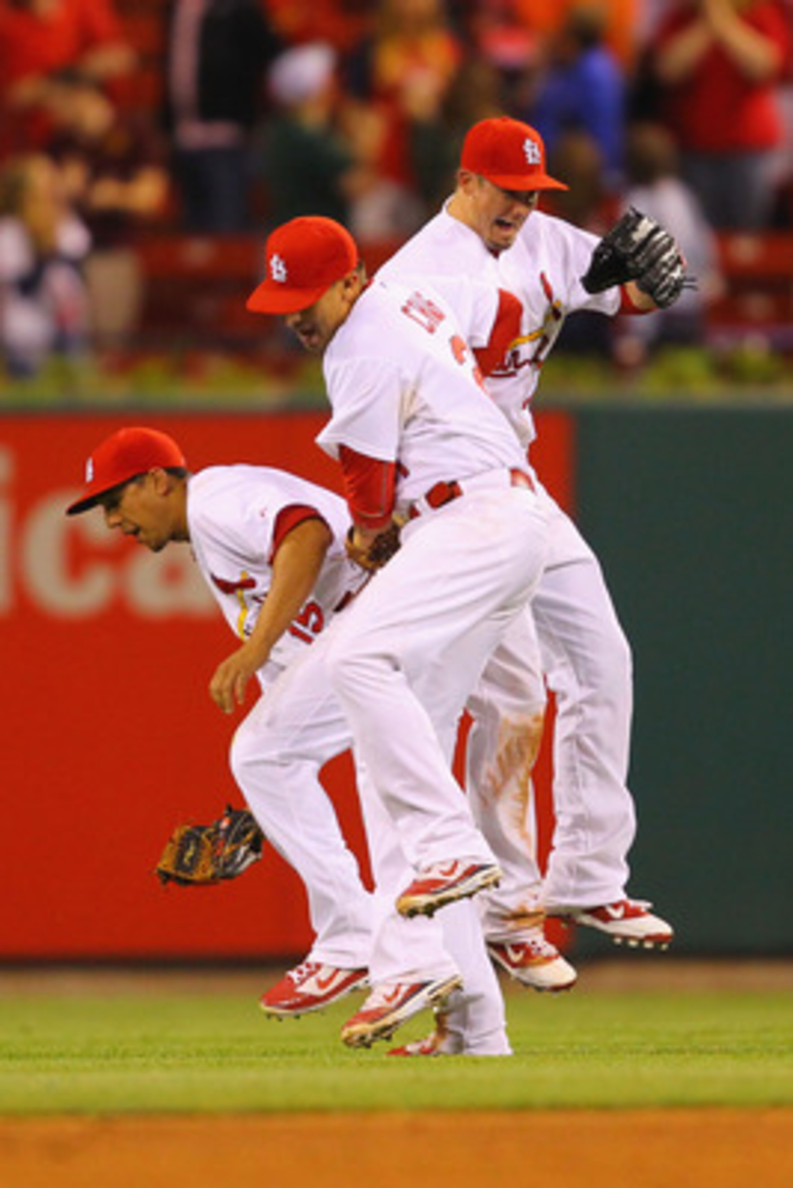 ST. LOUIS, MO - MAY 18: Jon Jay #15, Allen Craig #21 and Tyler Greene #27 all of the St.Louis Cardinals celebrate a victory over the Houston Astros at Busch Stadium on May 18, 2011 in St. Louis, Missouri.  (Photo by Dilip Vishwanat/Getty Images)