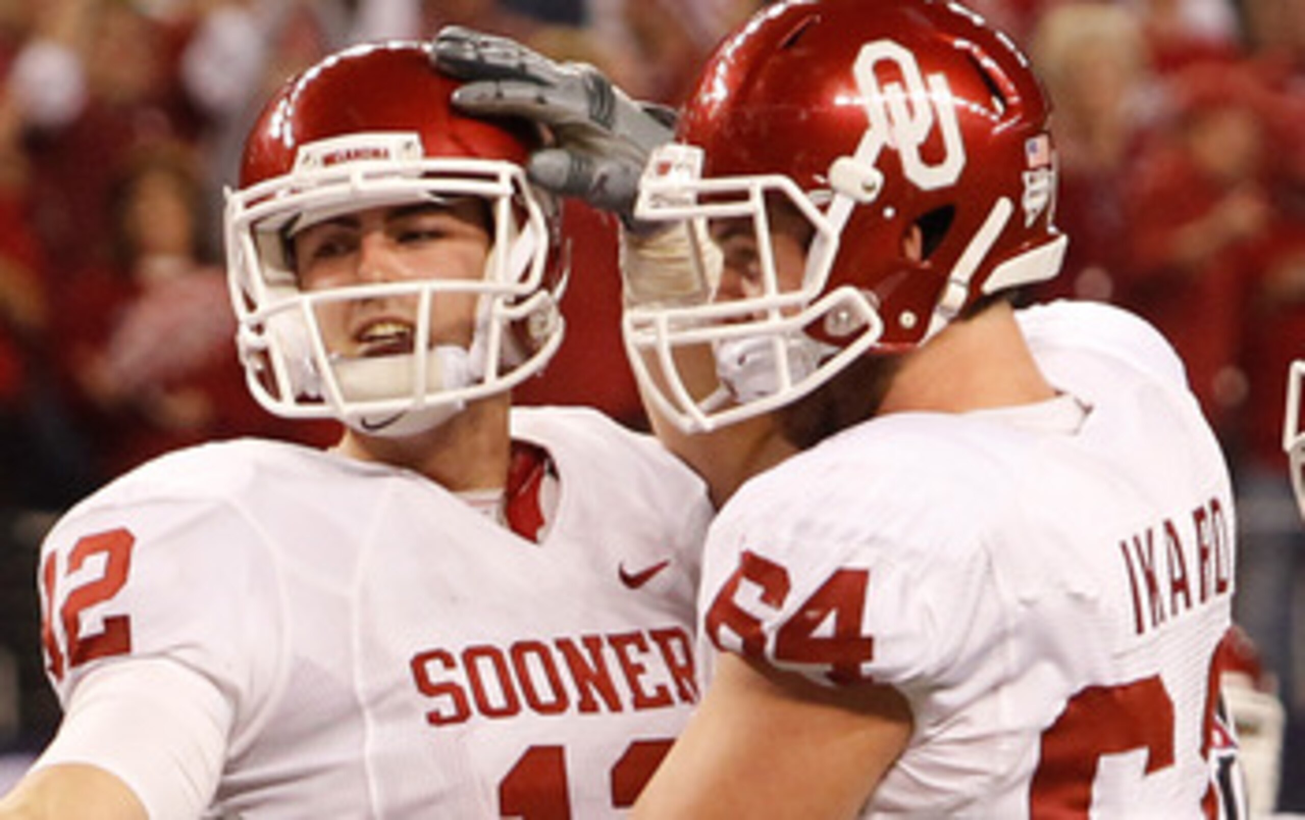 ARLINGTON, TX - DECEMBER 04:  Quarterback Landry Jones #12 of the Oklahoma Sooners celebrates with guard Gabe Ikard #64 after Jones scored against the Nebraska Cornhuskers at Cowboys Stadium on December 4, 2010 in Arlington, Texas.  (Photo by Tom Penningt