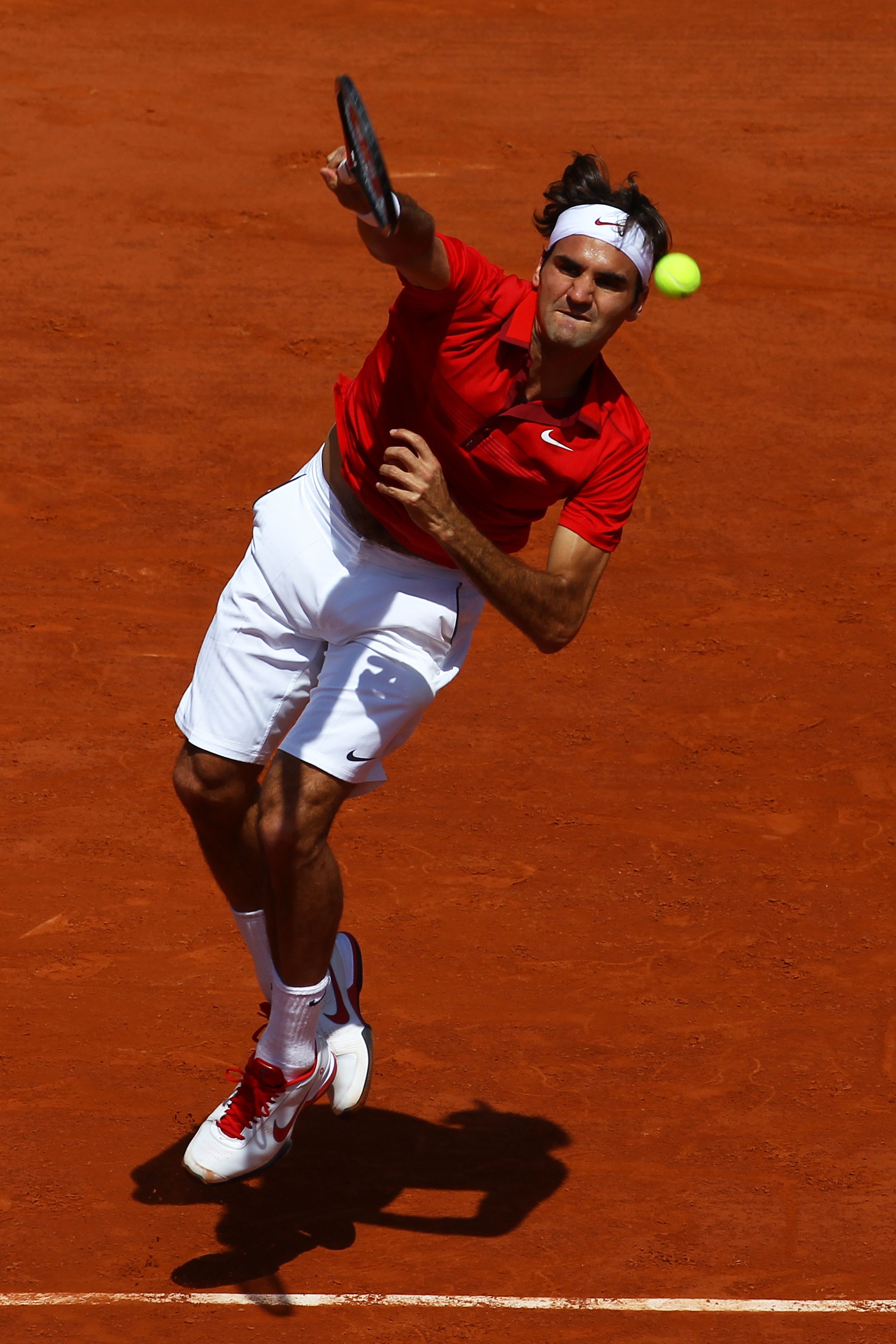 PARIS, FRANCE - MAY 29:  Roger Federer of Switzerland serves during the men's singles round four match between Stanislas Wawrinka of Switzerland and Roger Federer of Switzerland on day eight of the French Open at Roland Garros on May 29, 2011 in Paris, Fr
