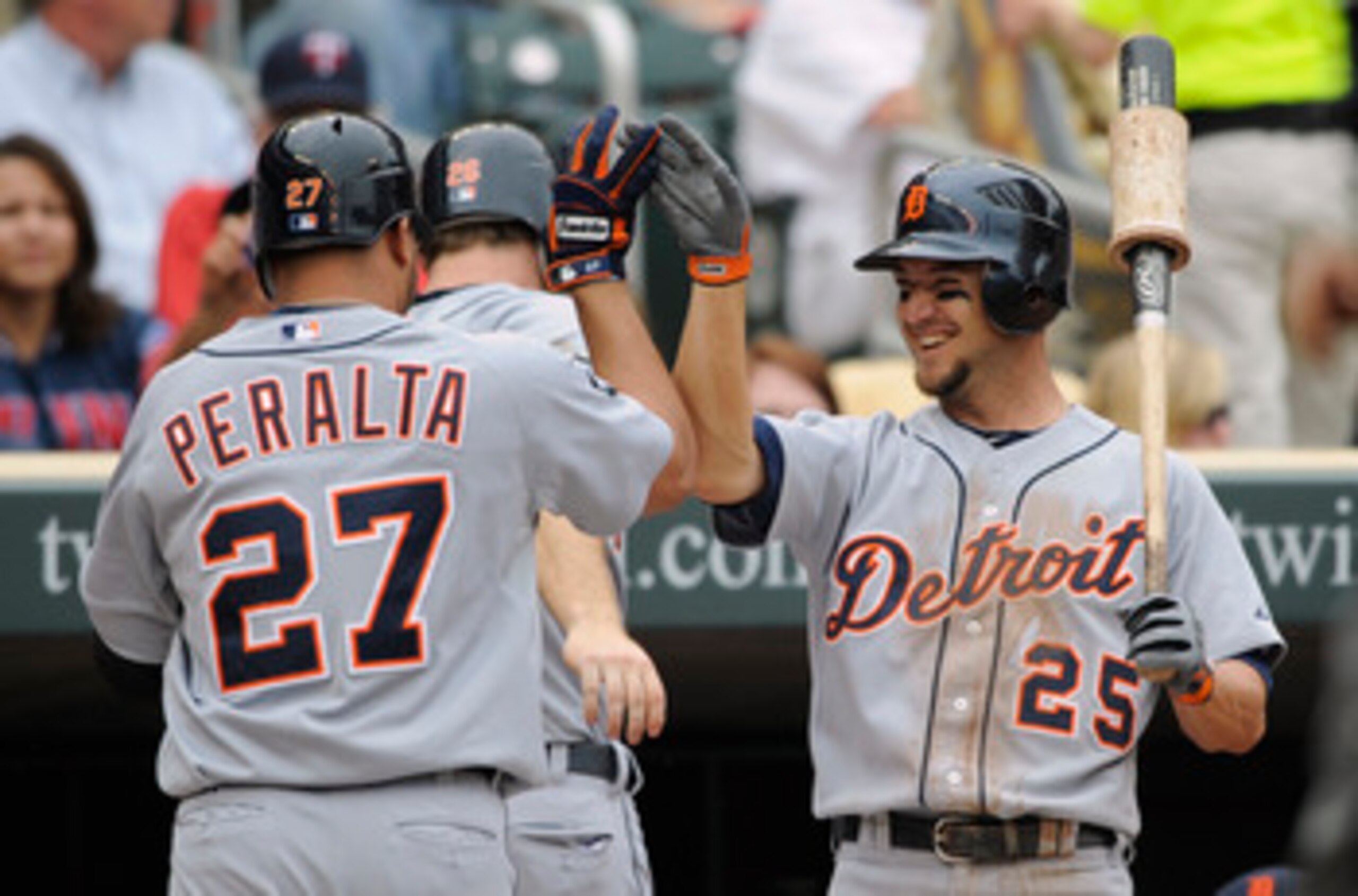 MINNEAPOLIS, MN - MAY 11: Jhonny Peralta #27 and Ryan Raburn #25 of the Detroit Tigers celebrate a two-run home run by Peralta against the Minnesota Twins during in the eighth inning of their game on May 11, 2011 at Target Field in Minneapolis, Minnesota.