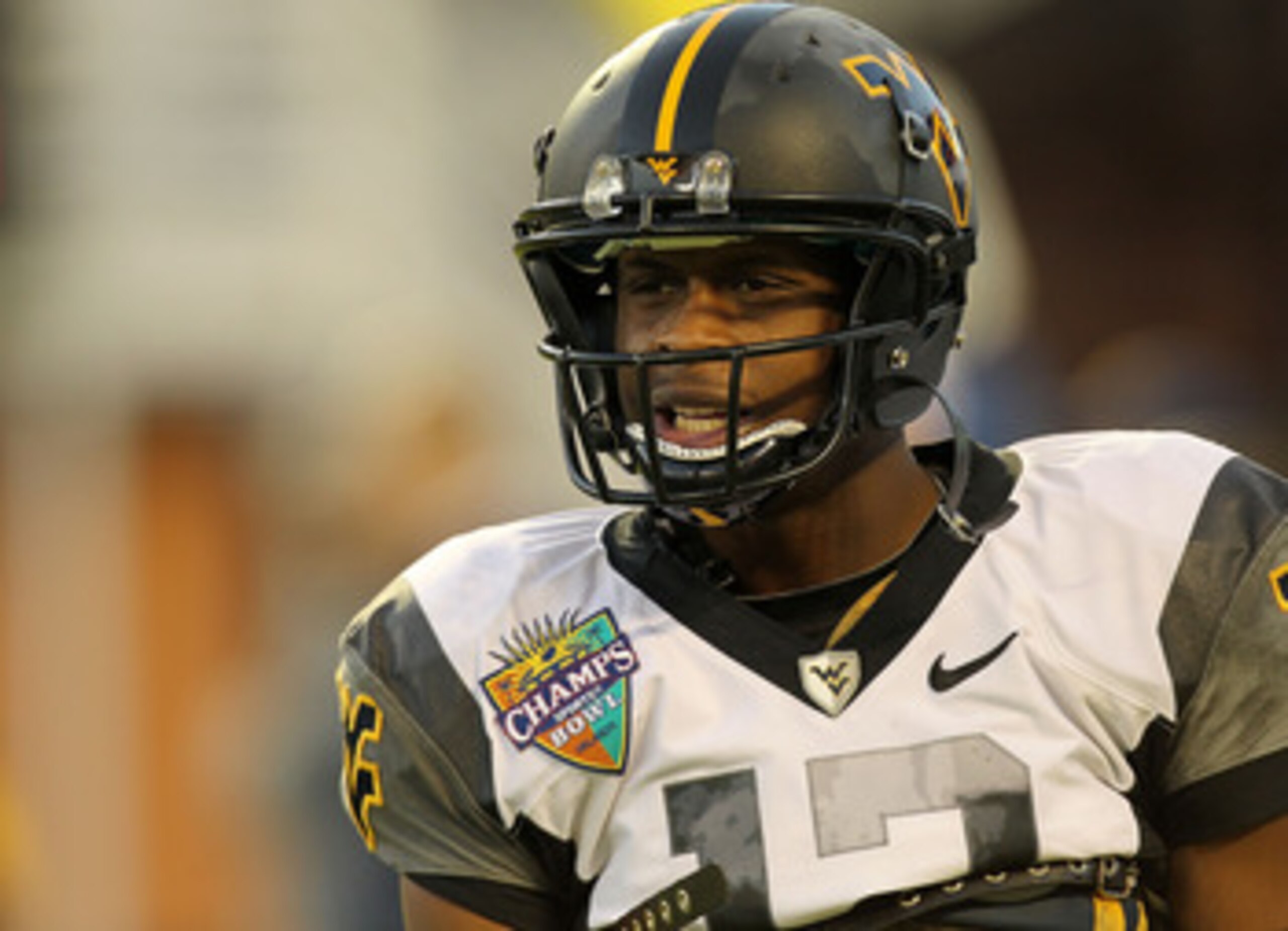 ORLANDO, FL - DECEMBER 28: Geno Smith #12 of the West Virginia Mountineers warms up during the Champs Sports Bowl against the North Carolina State Wolfpack at Florida Citrus Bowl Stadium on December 28, 2010 in Orlando, Florida.  (Photo by Mike Ehrmann/Ge