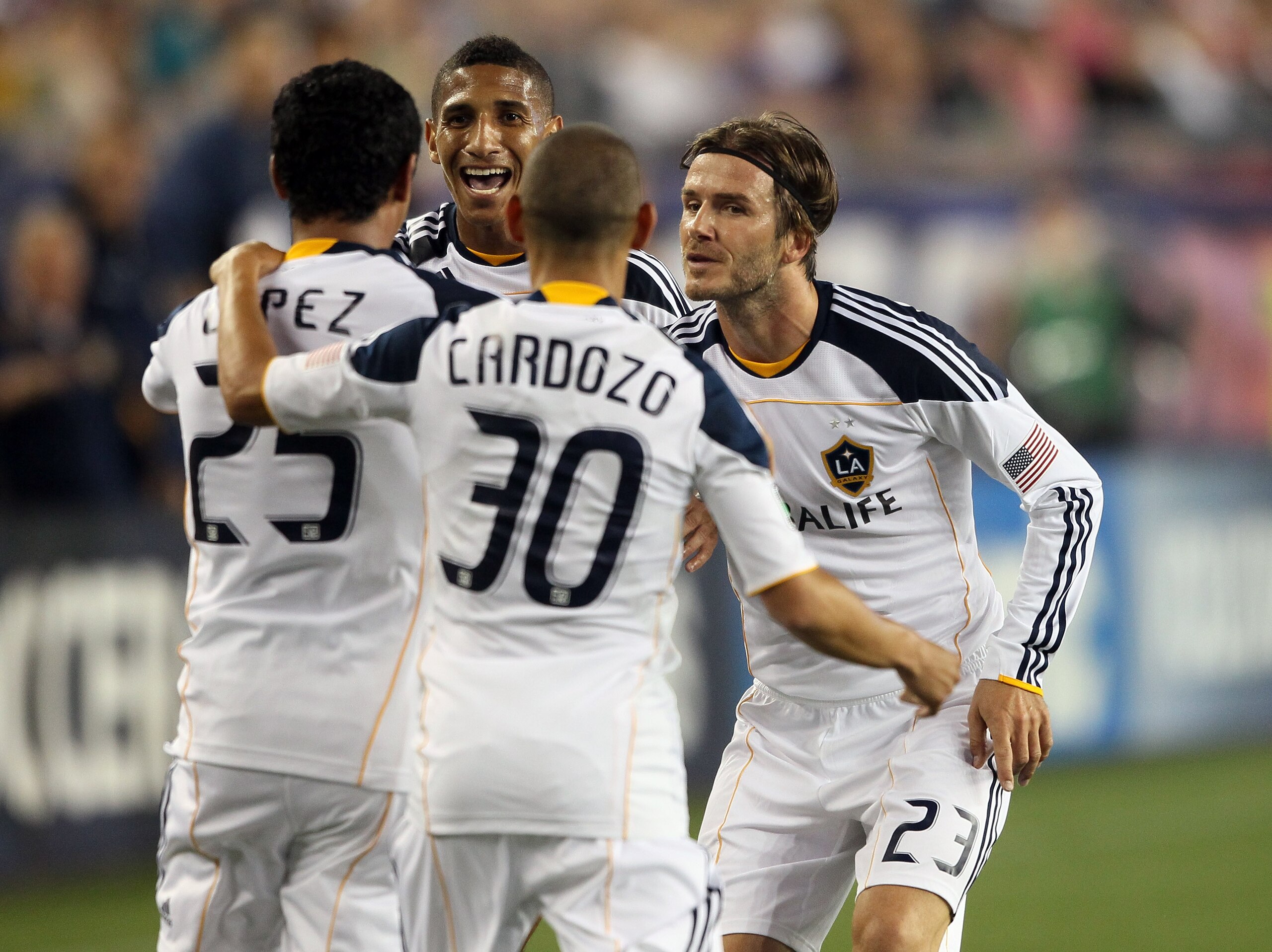 FOXBORO, MA - MAY 28:  Miguel Lopez #25 of the Los Angeles Galaxy is congratulated by teammates David Beckham #23, Sean Franklin #5 and Paolo Cardozo #30 after Lopez scored the game winning goal in the second half against the New England Revolution on May