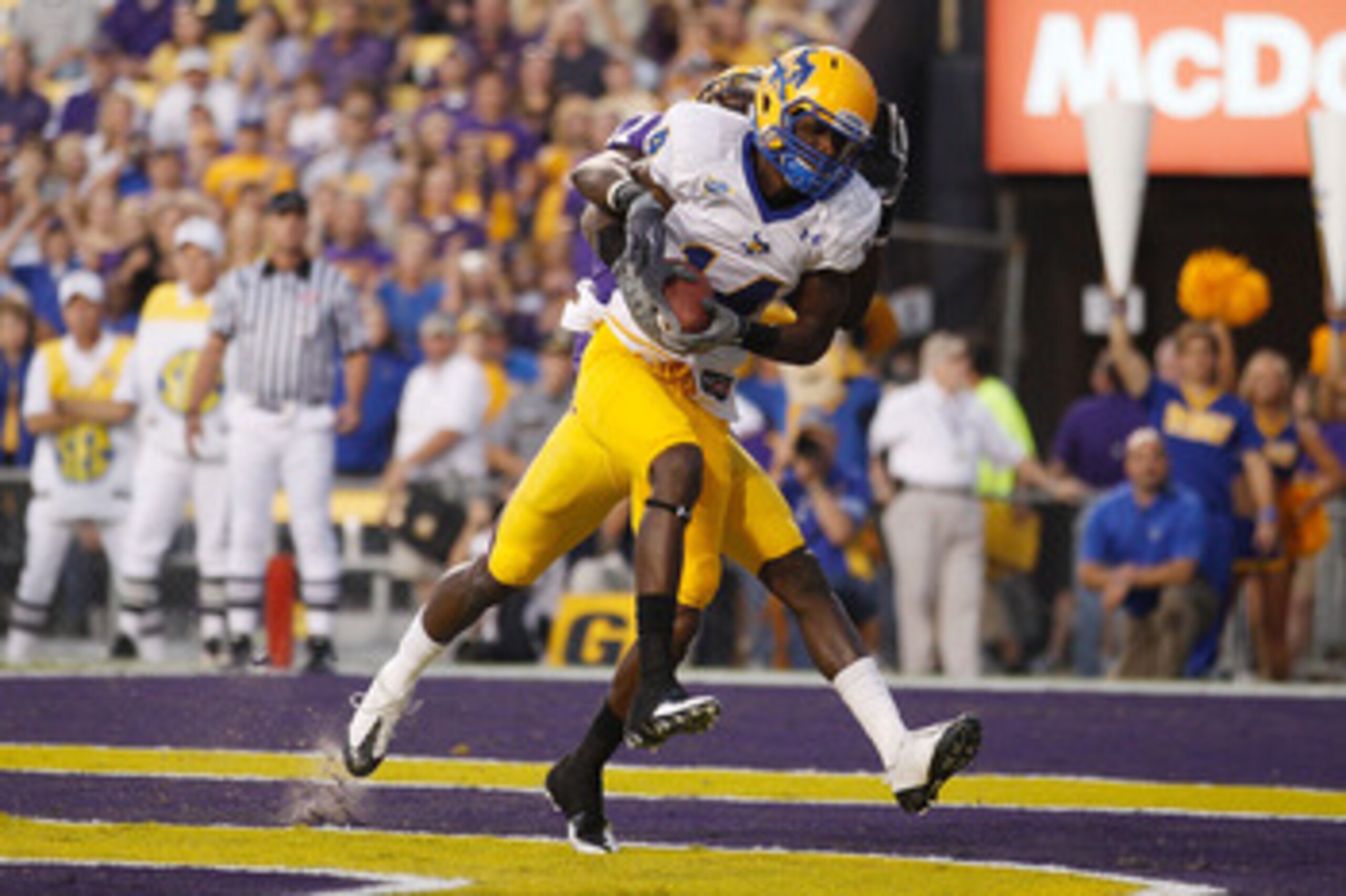 BATON ROUGE, LA - OCTOBER 16:  Damion Dixon #14 of the McNeese State Cowboys catches a touchdown pass over Morris Claiborne #17 of the Louisiana State University Tigers at Tiger Stadium on October 16, 2010 in Baton Rouge, Louisiana.  (Photo by Chris Grayt