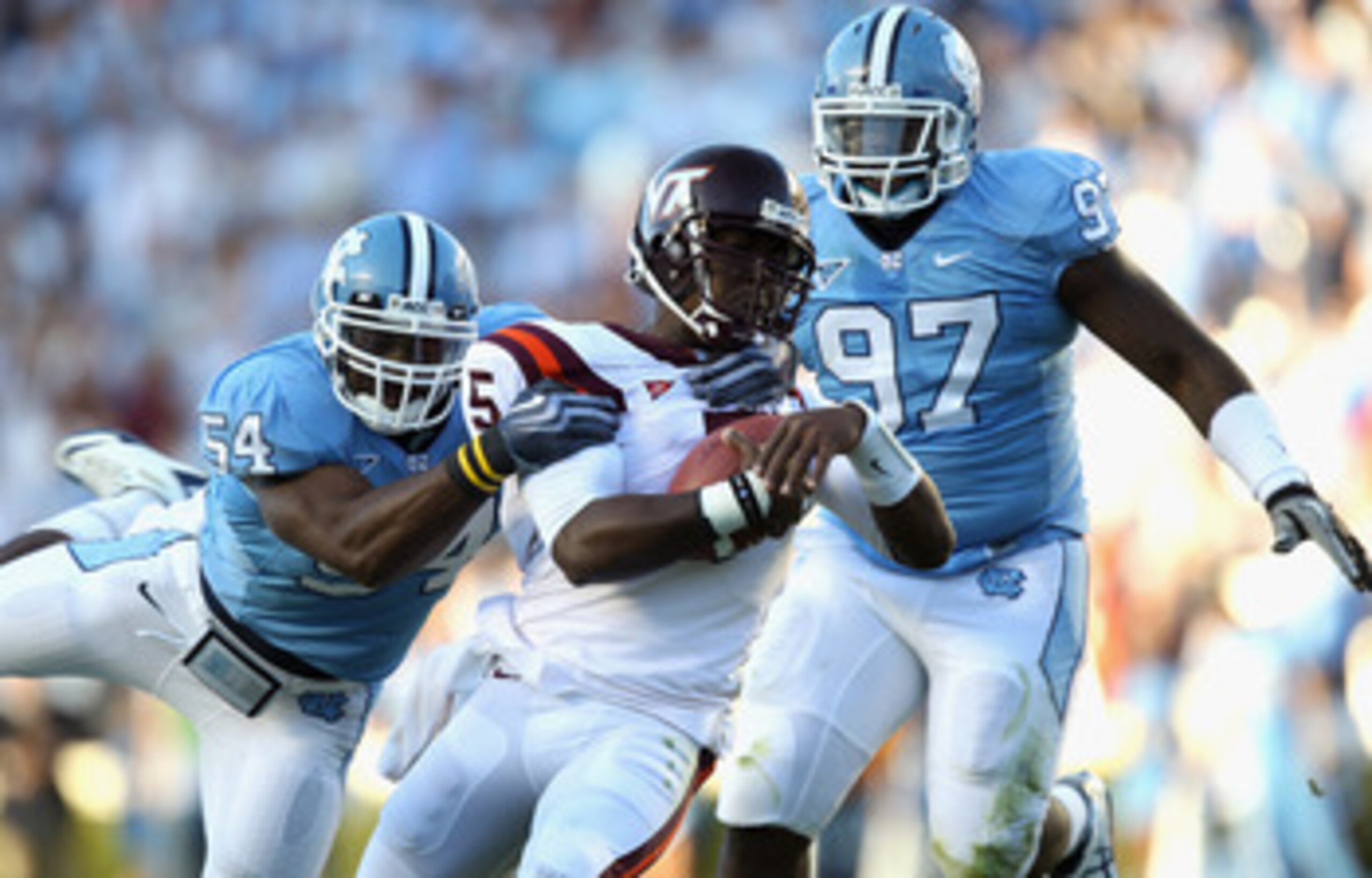 CHAPEL HILL, NC - NOVEMBER 13:  Tyrod Taylor #5 of the Virginia Tech Hokies is tackled by Bruce Carter #54 and teammate Jared McAdoo #97 of the North Carolina Tar Heels during their game at Kenan Stadium on November 13, 2010 in Chapel Hill, North Carolina