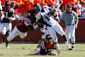 BLACKSBURG, VA - SEPTEMBER 18:  Defensive end J.R. Collins #42 and  cornerback Kyle Fuller #17 of the Virginia Tech Hokies tackle wide receiver Dwayne Harris #17 of the East Carolina Pirates at Lane Stadium on September 18, 2010 in Blacksburg, Virginia.  