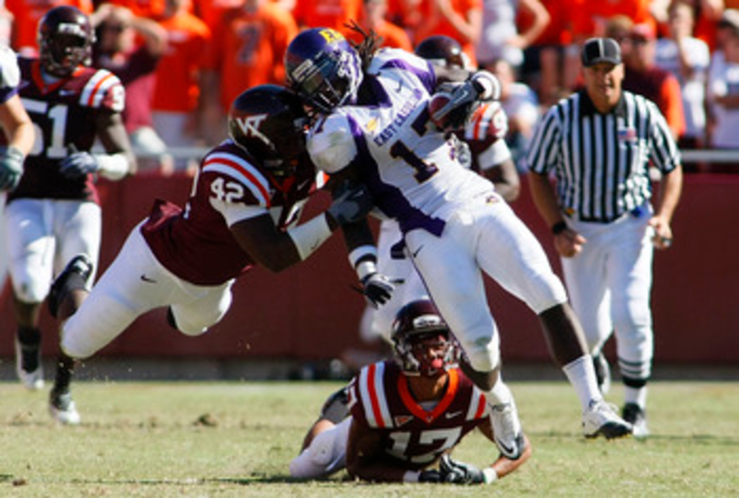 BLACKSBURG, VA - SEPTEMBER 18:  Defensive end J.R. Collins #42 and  cornerback Kyle Fuller #17 of the Virginia Tech Hokies tackle wide receiver Dwayne Harris #17 of the East Carolina Pirates at Lane Stadium on September 18, 2010 in Blacksburg, Virginia.  