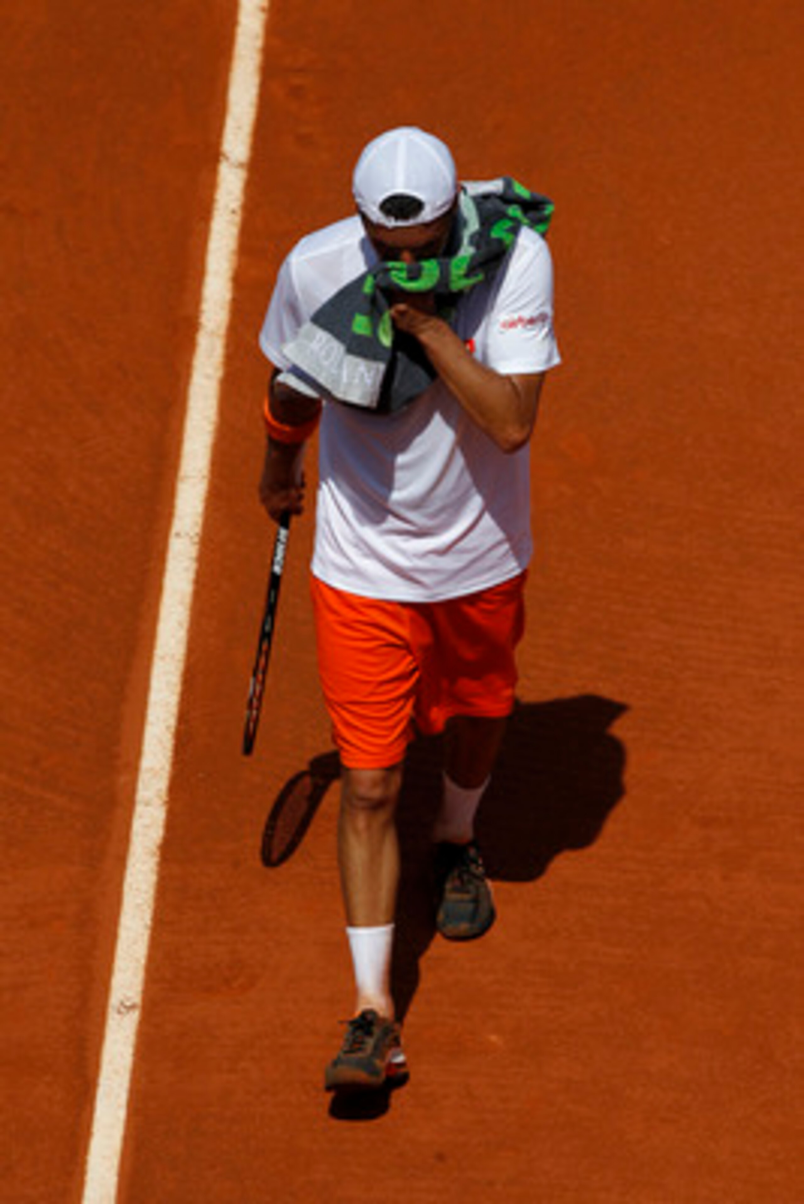 PARIS, FRANCE - MAY 29: Albert Montanes of Spain wipes his face with a towel during the men's singles round four match between Fabio Fognini of Italy and Albert Montanes of Spain on day eight of the French Open at Roland Garros on May 29, 2011 in Paris, PARIS, FRANCE - MAY 29: Albert Montanes of Spain wipes his face with a towel during the men's singles round four match between Fabio Fognini of Italy and Albert Montanes of Spain on day eight of the French Open at Roland Garros on May 29, 2011 in Paris,