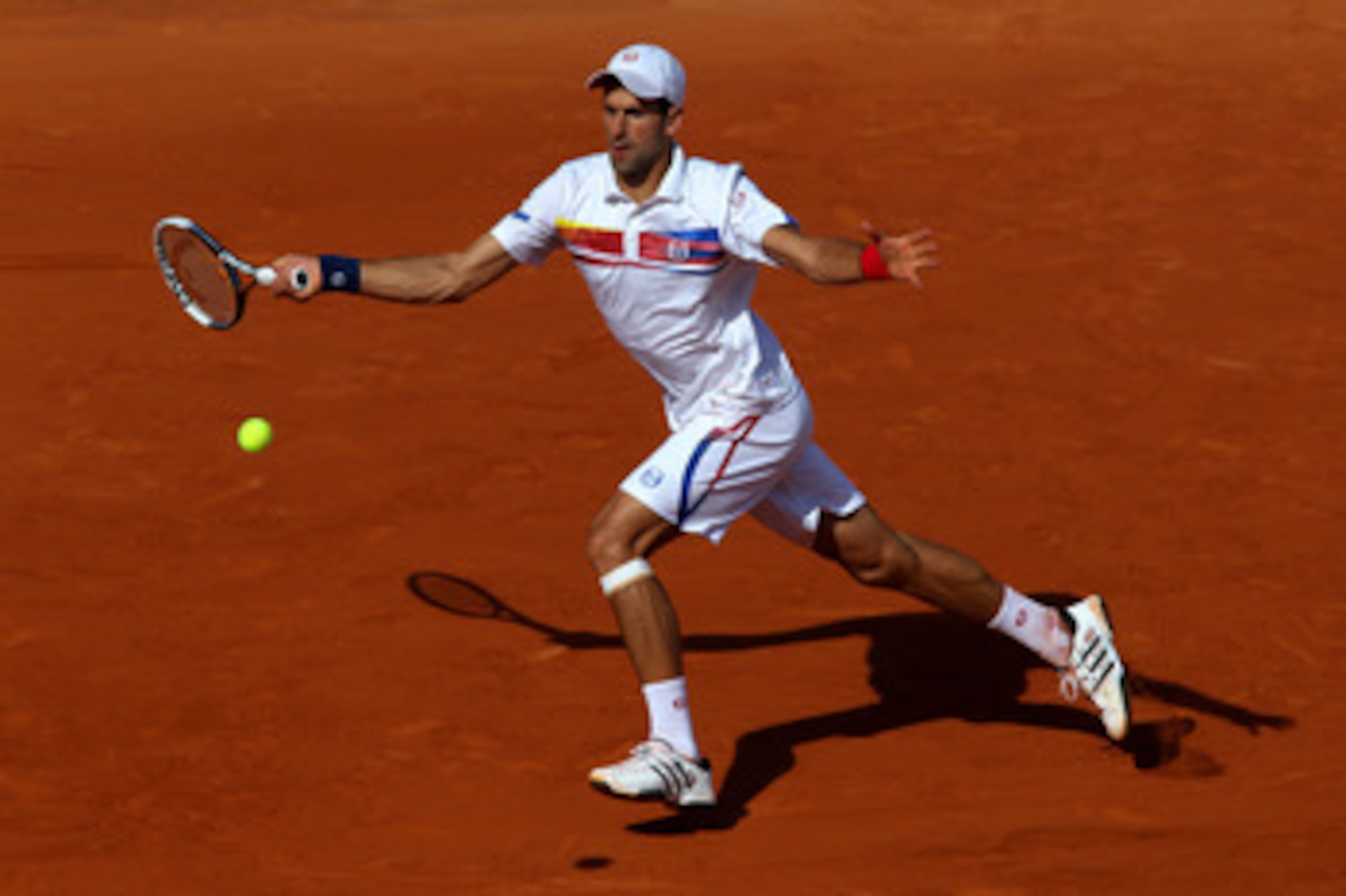 PARIS, FRANCE - MAY 29:  Novak Djokovic of Serbia hits a forehand during the men's singles round four match between Richard Gasquet of France and Novak Djokovic of Serbia on day eight of the French Open at Roland Garros on May 29, 2011 in Paris, France.