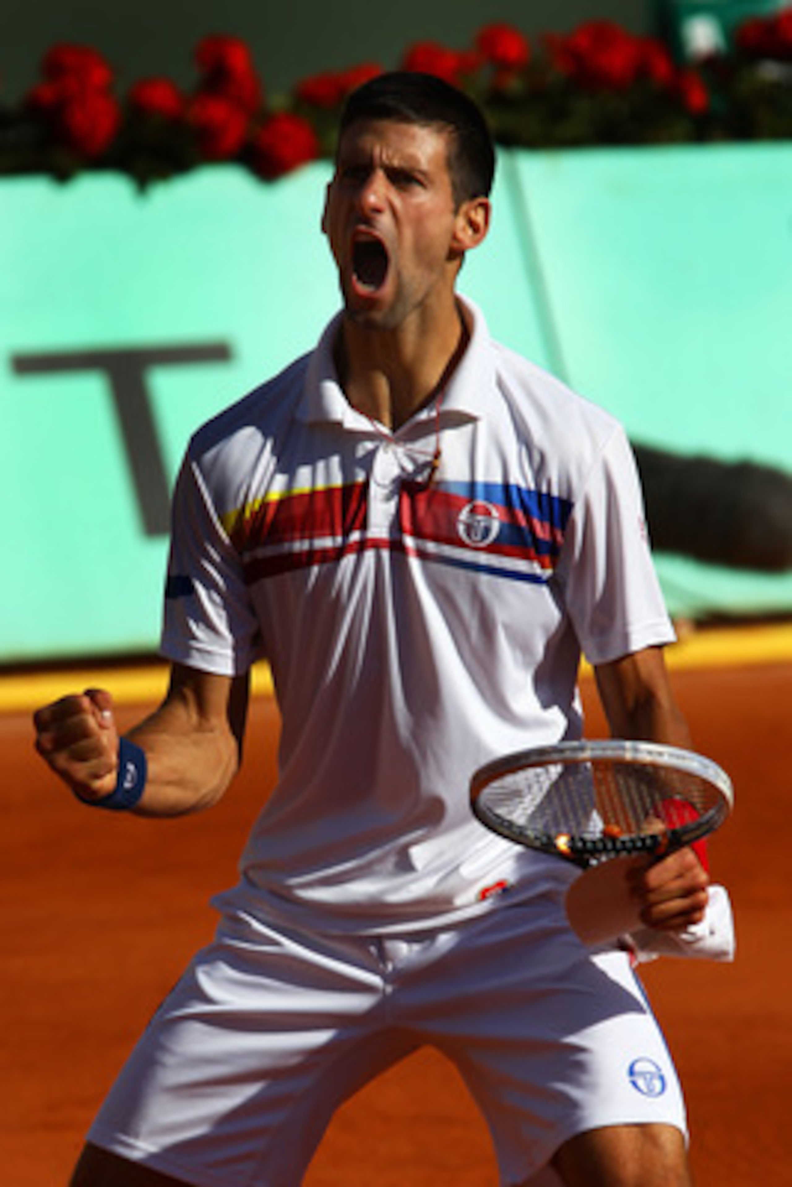 PARIS, FRANCE - MAY 29:  Novak Djokovic of Serbia celebrates matchpoint during the men's singles round four match between Richard Gasquet of France and Novak Djokovic of Serbia on day eight of the French Open at Roland Garros on May 29, 2011 in Paris, Fra