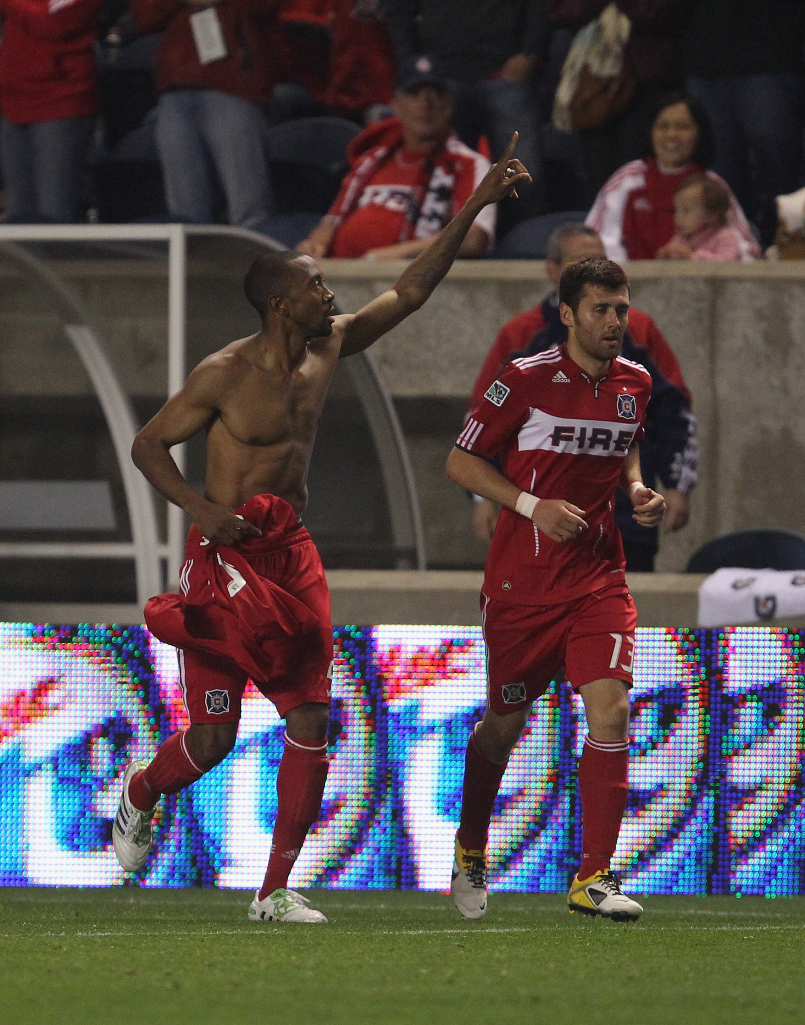 BRIDGEVIEW, IL - MAY 28: Cory Gibbs #5 of the Chicago Fire celebrates a second half goal against the San Jose Earthquakes with teammate Gonzalo Segares #13 during an MLS match at Toyota Park on May 28, 2011 in Bridgeview, Illinois. The Fire and the Earthq