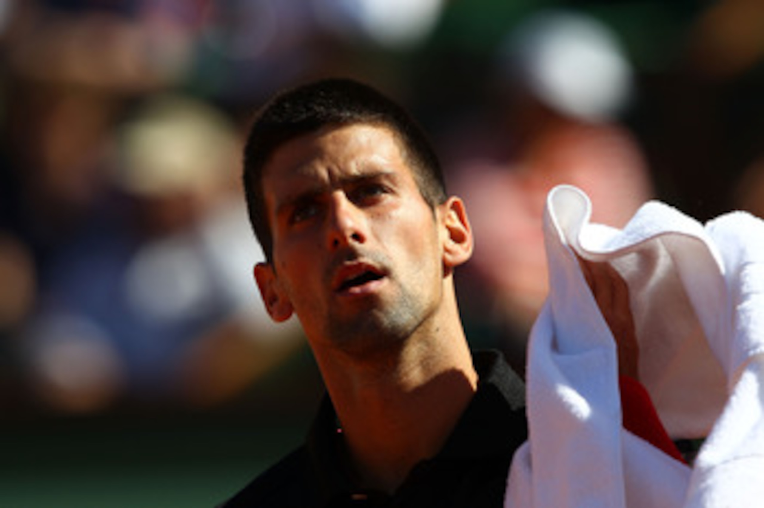PARIS, FRANCE - MAY 25:  Novak Djokovic of Serbia looks on during the men's singles round two match between Victor Hanescu of Romania and Novak Djokovic of Serbia on day four of the French Open at Roland Garros on May 25, 2011 in Paris, France.  (Photo by