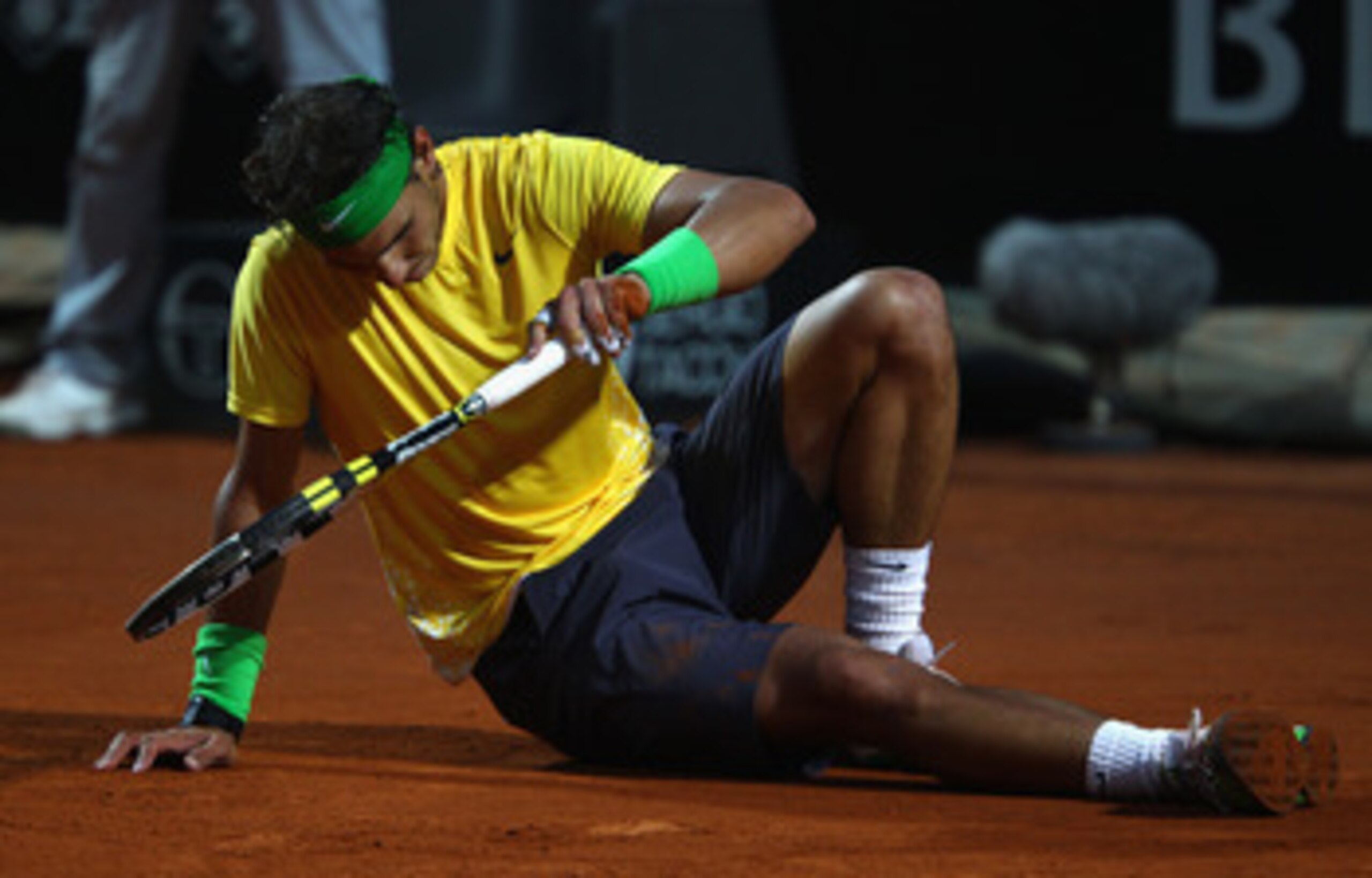 ROME, ITALY - MAY 15:  Rafael Nadal of Spain shows his dejection after falling during the final against Novak Djokovic of Serbia during day eight of the Internazoinali BNL D'Italia at the Foro Italico Tennis Centre on May 15, 2011 in Rome, Italy.  (Photo 