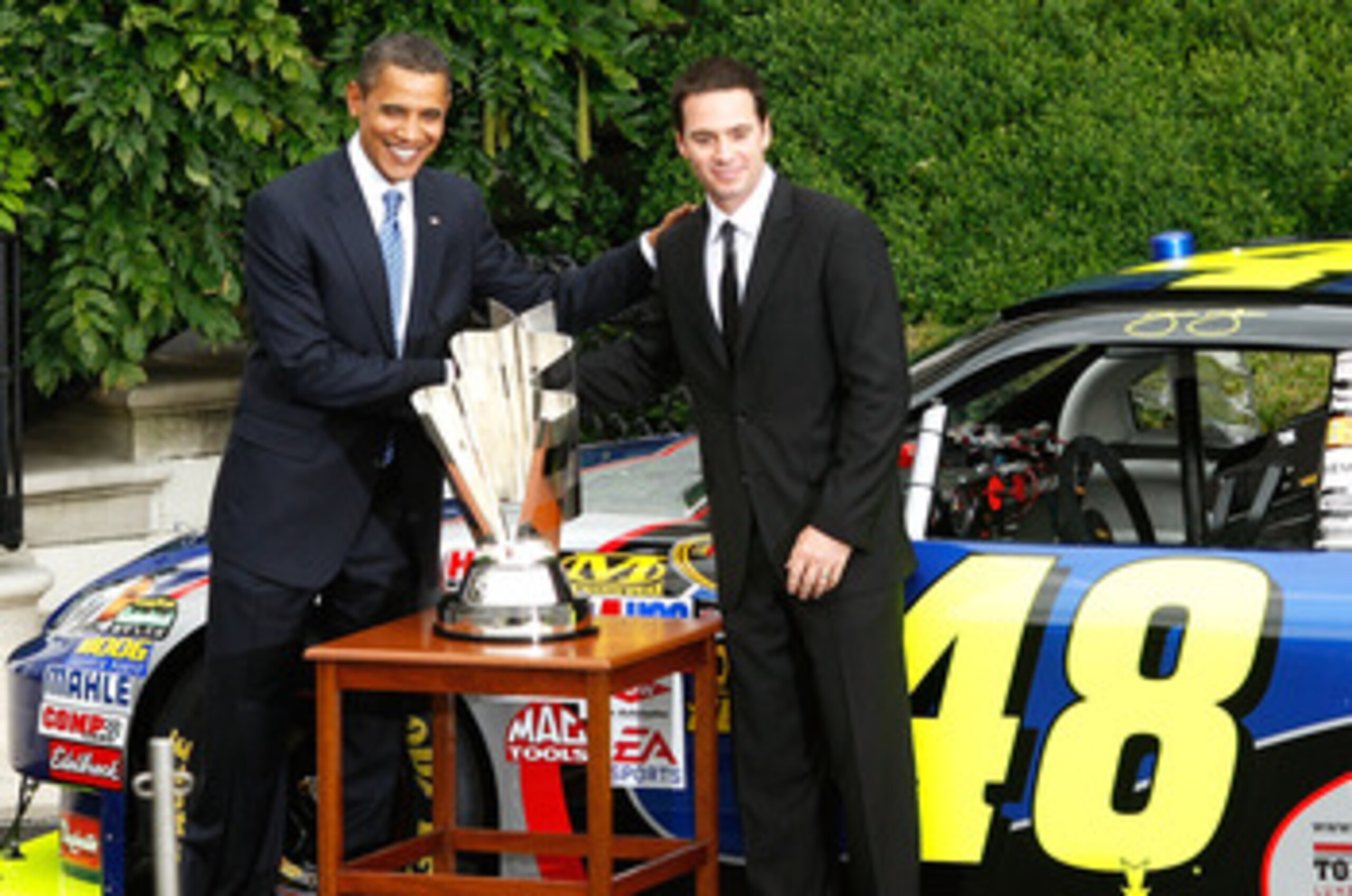 WASHINGTON - AUGUST 19:  U.S. President Barack Obama (L) poses for pictures with 2008 NASCAR Sprint Cup Champion Jimmie Johnson (R) during a South Portico event at the White House August 19, 2009 in Washington, DC. Obama hosted the NASCAR champion and oth