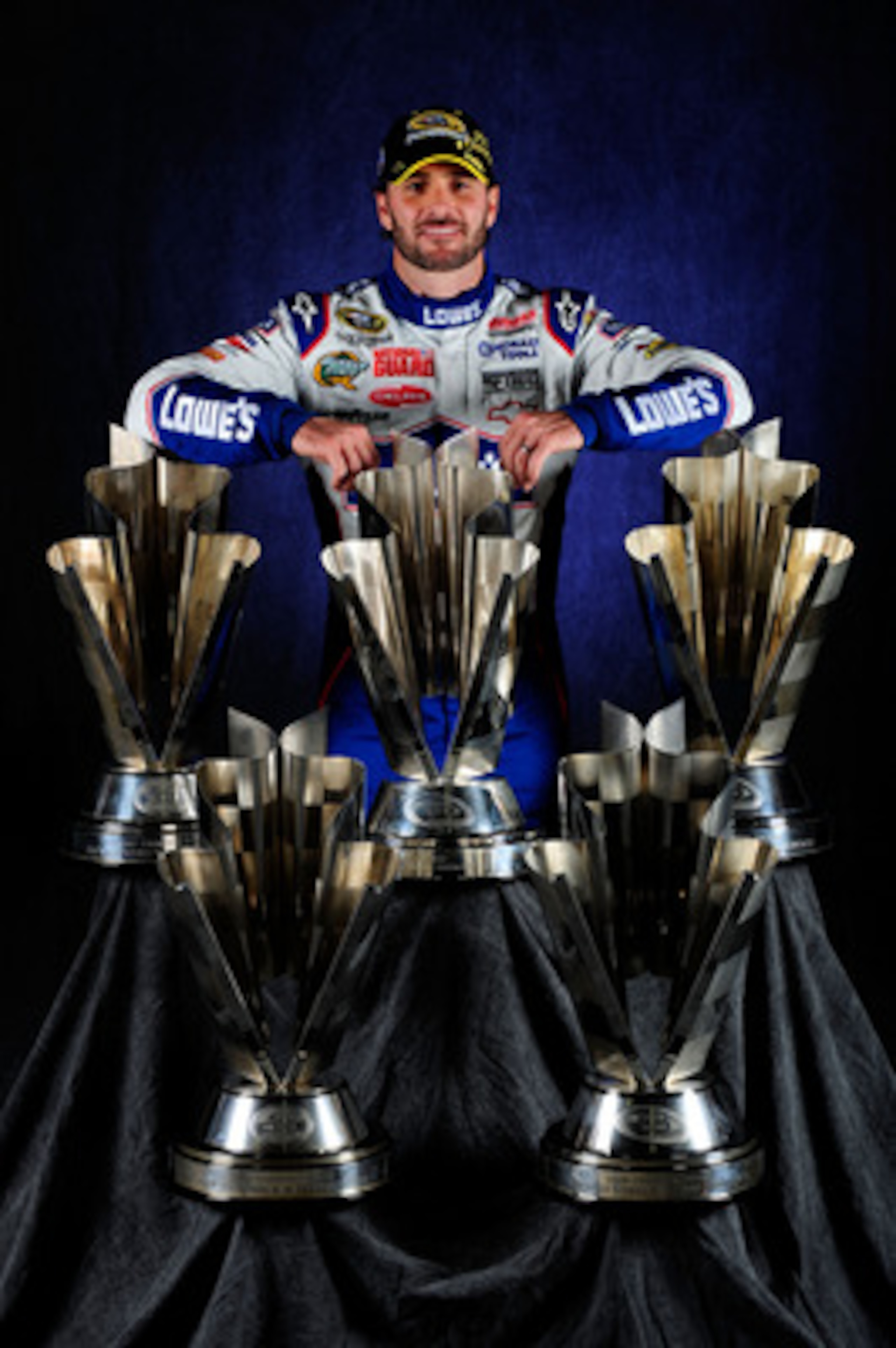 HOMESTEAD, FL - NOVEMBER 21:  NASCAR Champion Jimmie Johnson, driver of the #48 Lowe's Chevrolet, poses with the Sprint Cup Series Championship trophies at Homestead-Miami Speedway on November 21, 2010 in Homestead, Florida. Johnson clinched his fifth str