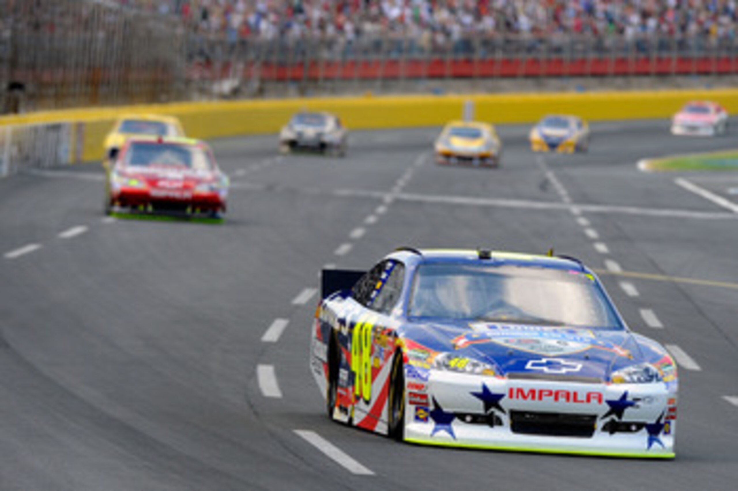 CONCORD, NC - MAY 29:  Jimmie Johnson, driver of the #48 Lowe's Summer Salute Chevrolet, leads a group of cars during the NASCAR Sprint Cup Series Coca-Cola 600 at Charlotte Motor Speedway on May 29, 2011 in Concord, North Carolina.  (Photo by Jared C. Ti