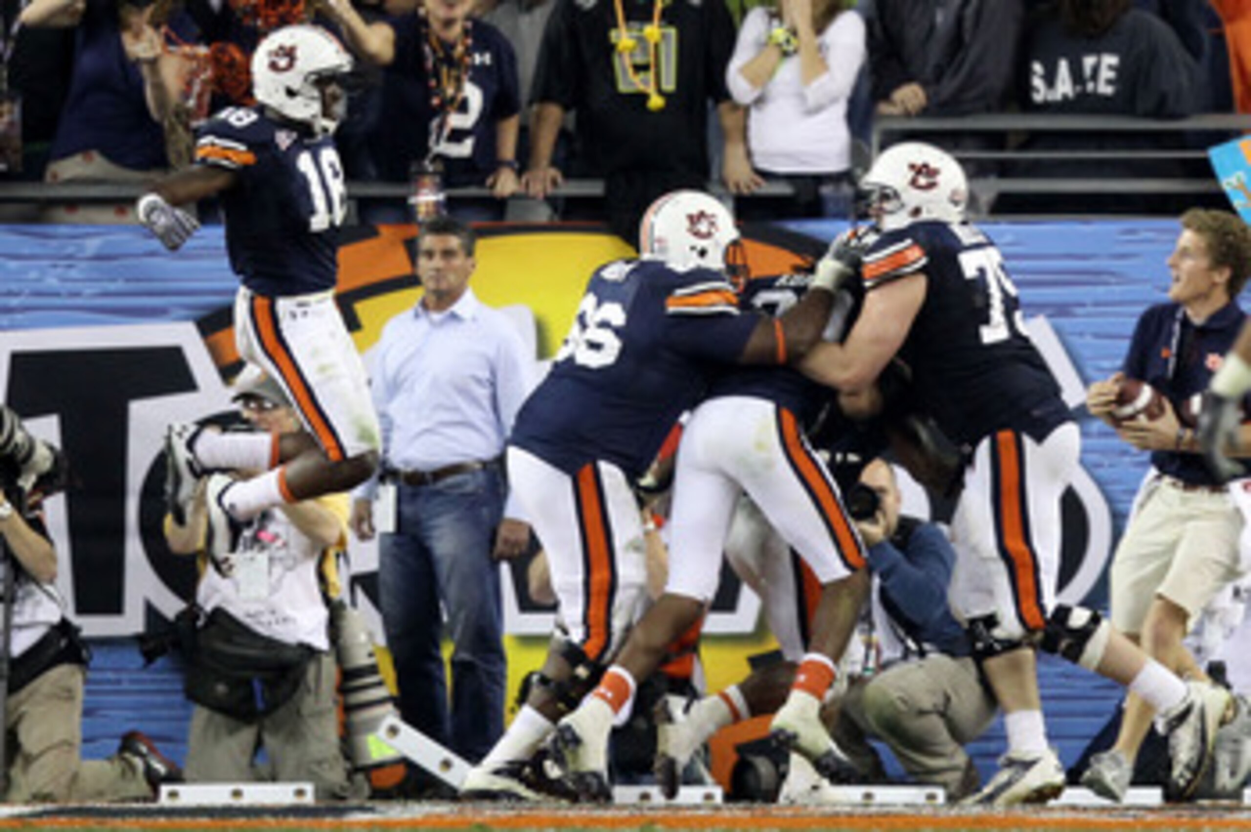 GLENDALE, AZ - JANUARY 10:  Michael Dyer #5 of the Auburn Tigers celebrates with teammates Brandon Mosley #75 and Kodi Burns #18 after he ran the ball for 16-yards and is called down at the one-yardline with 10 seconds remaining in the fourth quarter agai
