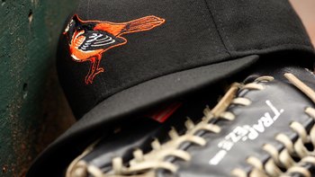 ARLINGTON, TX - APRIL 08:  Detail view of a hat and glove of the Baltimore Orioles resting in the dugout during the game against the Texas Rangers on April 8, 2008 at Rangers Ballpark in Arlington, Texas. The Orioles defeated the Rangers 8-1.  (Photo by C