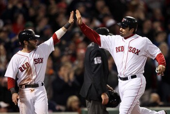 BOSTON, MA - MAY 22:  Dustin Pedroia #15 and Adrian Gonzalez #28 of the Boston Red Sox celebrate after they scored in the seventh inning against the Chicago Cubs on May 22, 2011 at Fenway Park in Boston, Massachusetts.  Before this series, the two teams h