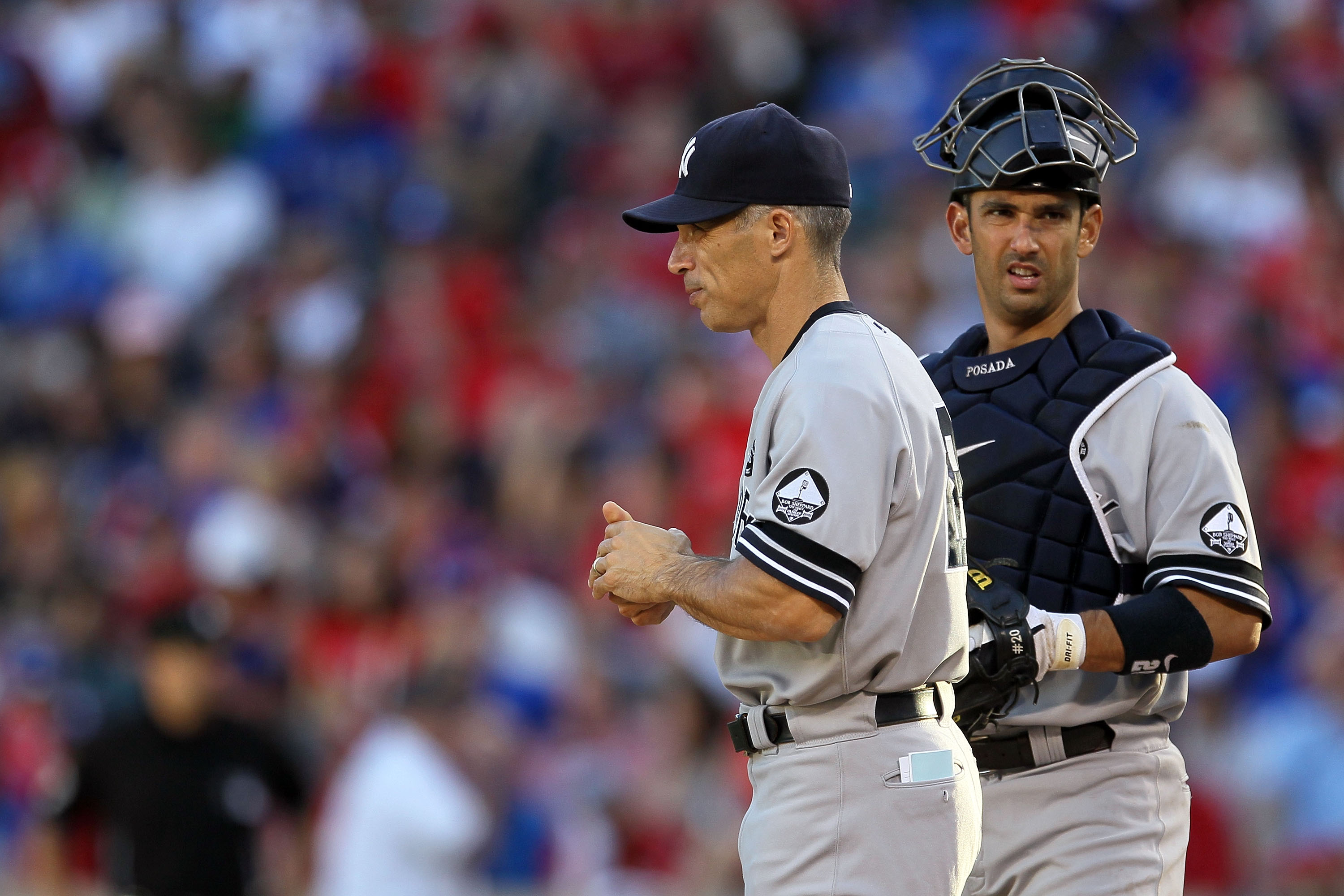 ARLINGTON, TX - OCTOBER 16:  Manager Joe Girardi and Jorge Posada #20 of the New York Yankees stand on the mound during a pitching change against the Texas Rangers in Game Two of the ALCS during the 2010 MLB Playoffs at Rangers Ballpark in Arlington on Oc
