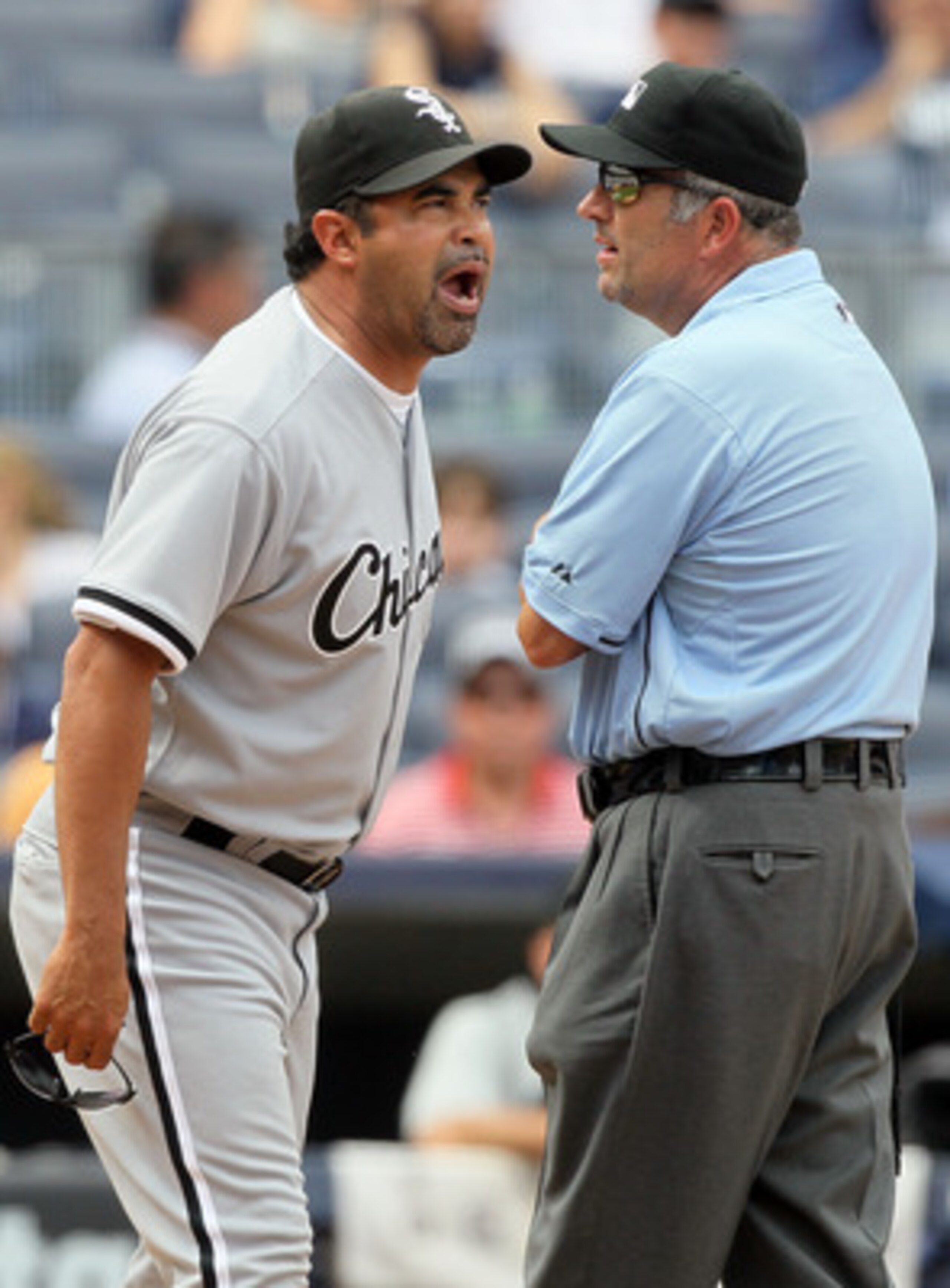 NEW YORK - MAY 02:  Manager Ozzie Guillen of the Chicago White Sox gets in a few last words with first base umpire Dale Scott after being ejected from the game against the New York Yankees by home plate umpire Dan Iassogna (not pictured) on May 2, 2010 at