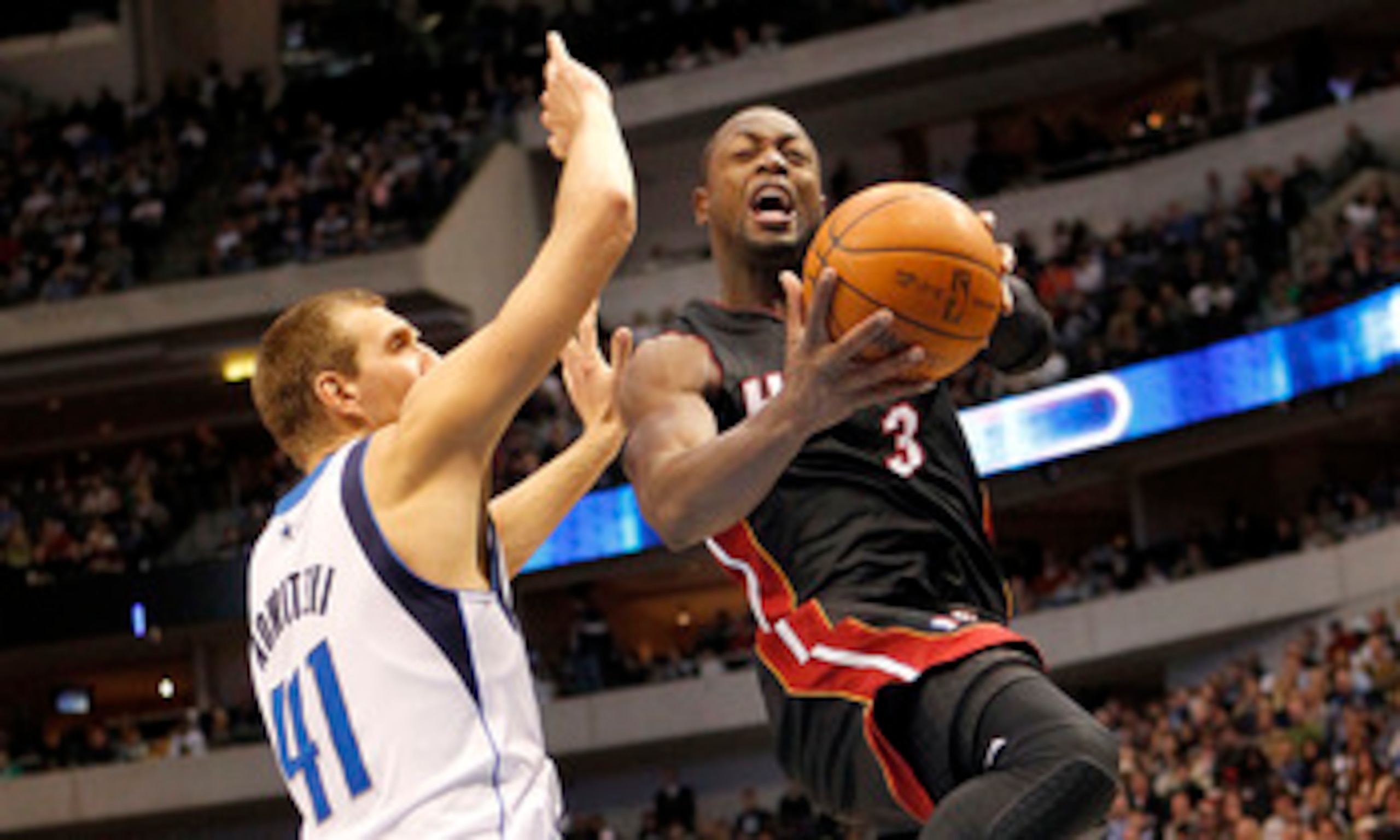 DALLAS - NOVEMBER 27: Dwyane Wade #3 of the Miami Heat drives by Dirk Nowitzki #41 of the Dallas Mavericks on November 27, 2010 at the American Airlines Center in Dallas, Texas. NOTE TO USER: User expressly acknowledges and agrees that, by downloading and