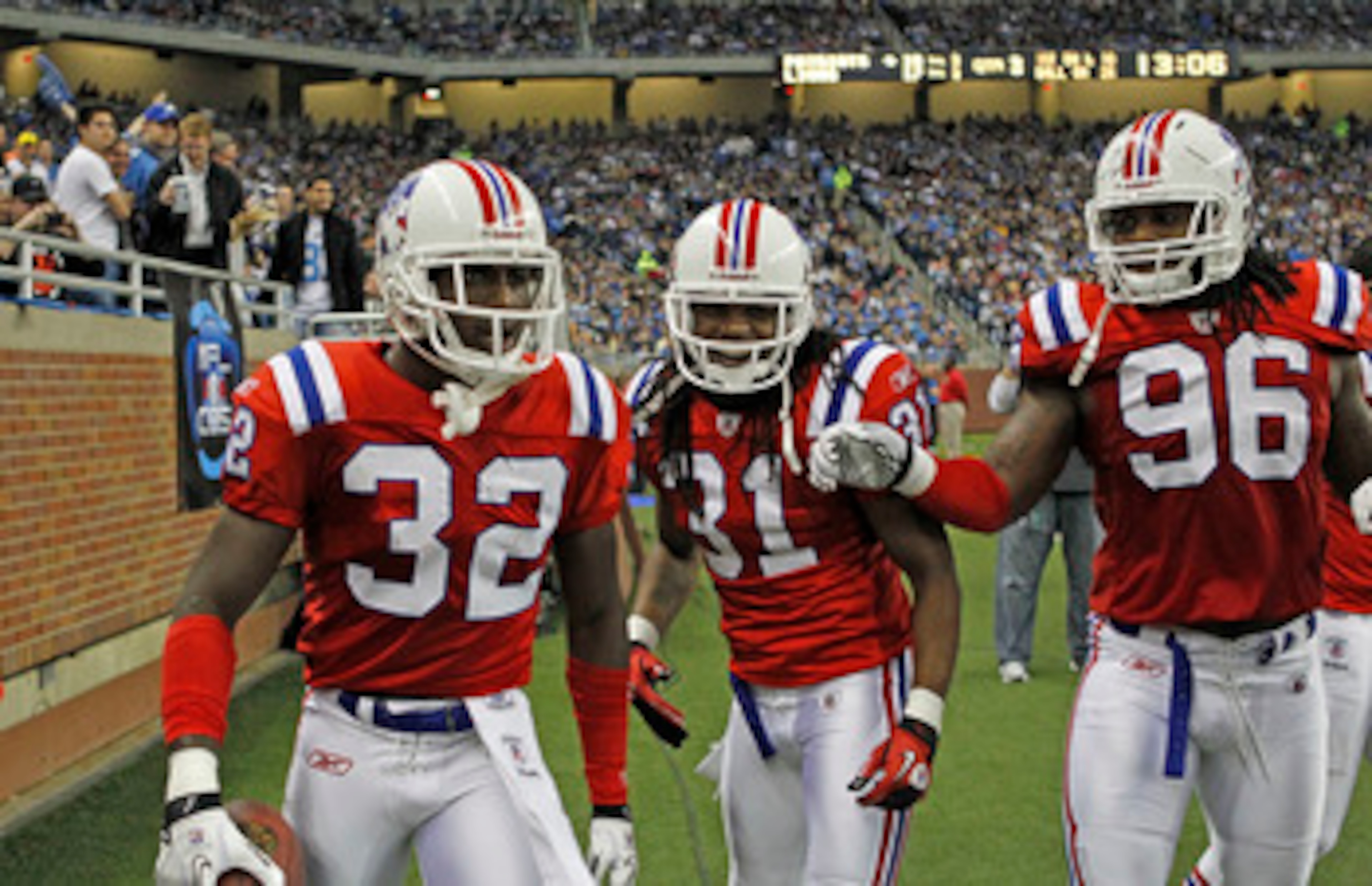DETROIT - NOVEMBER 25:  Devin McCourty #32 of the New England Patriots celebrates his interception with teammates Brandon Meriweather #31 and Jermaine Cunningham #96 during the fourth quarter of the game against the Detroit Lions at Ford Field on November