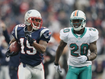 FOXBORO, MA - JANUARY 02:  Brandon Tate #19 of the New England Patriots carries the ball as Reshad Jones #20 of the Miami Dolphins chases after him on January 2, 2011 at Gillette Stadium in Foxboro, Massachusetts.  (Photo by Elsa/Getty Images)