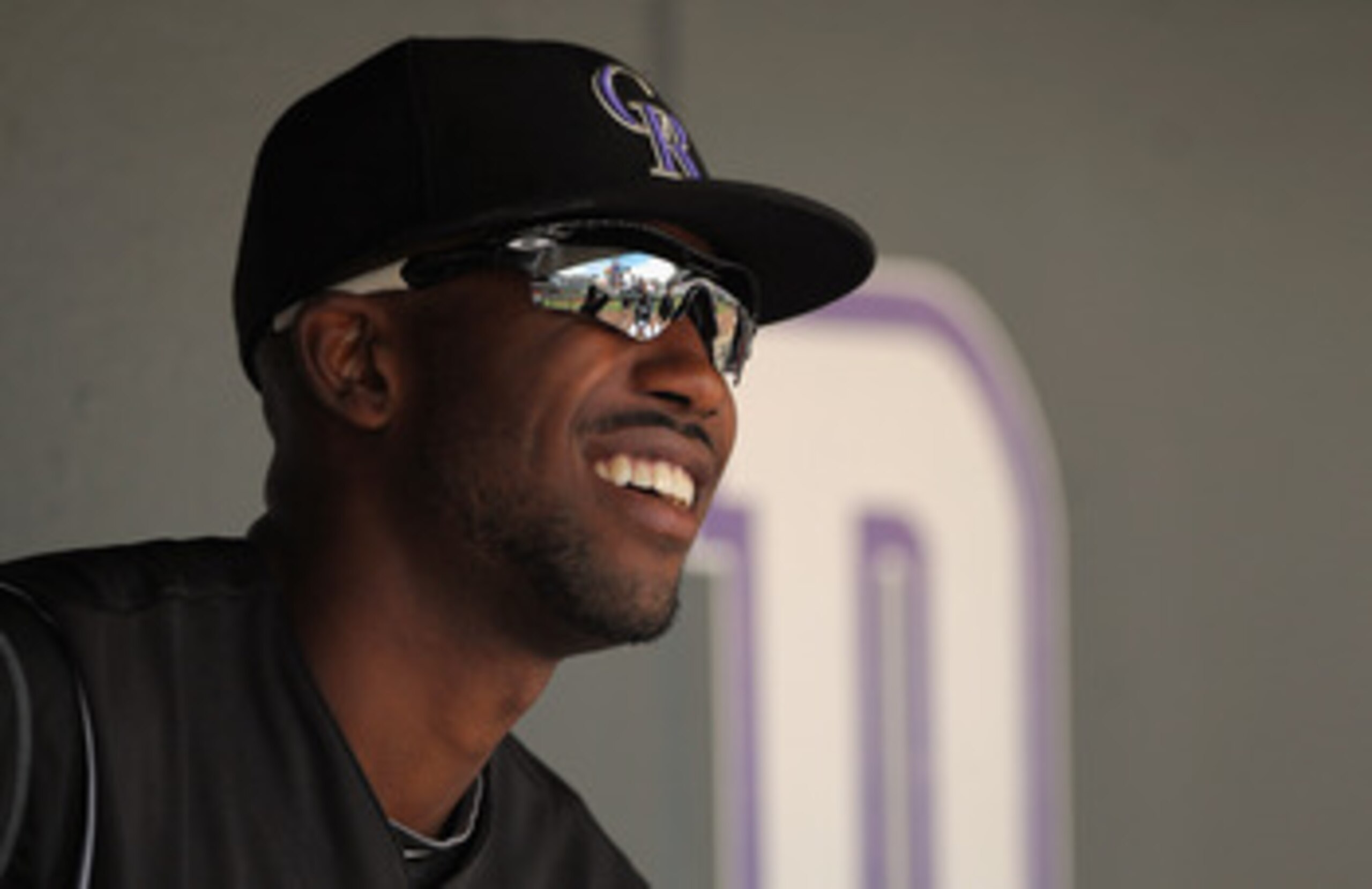 DENVER, CO - APRIL 17:  Dexter Fowler #24 of the Colorado Rockies looks on from the dugout prior to facing the Chicago Cubs at Coors Field on April 17, 2011 in Denver, Colorado.  (Photo by Doug Pensinger/Getty Images)