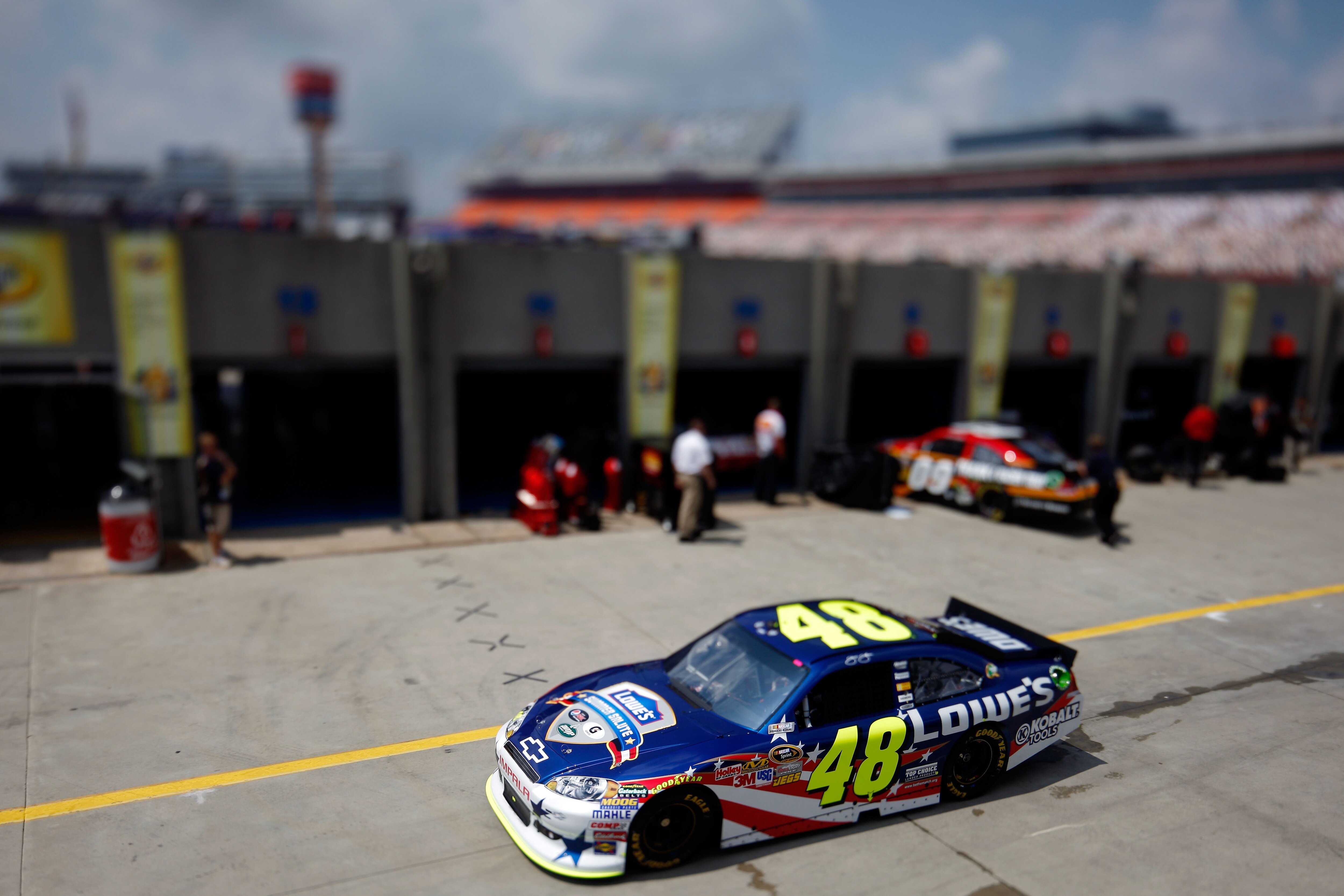 CHARLOTTE, NC - MAY 28:  (***EDITORS NOTE*** - THIS DIGITAL IMAGE WAS CREATED WITH THE USE OF VARIABLE FOCAL PLANE LENS) Jimmie Johnson drives the #48 Lowe's Summer Salute Chevrolet through the garage area during practice for the NASCAR Sprint Cup Series