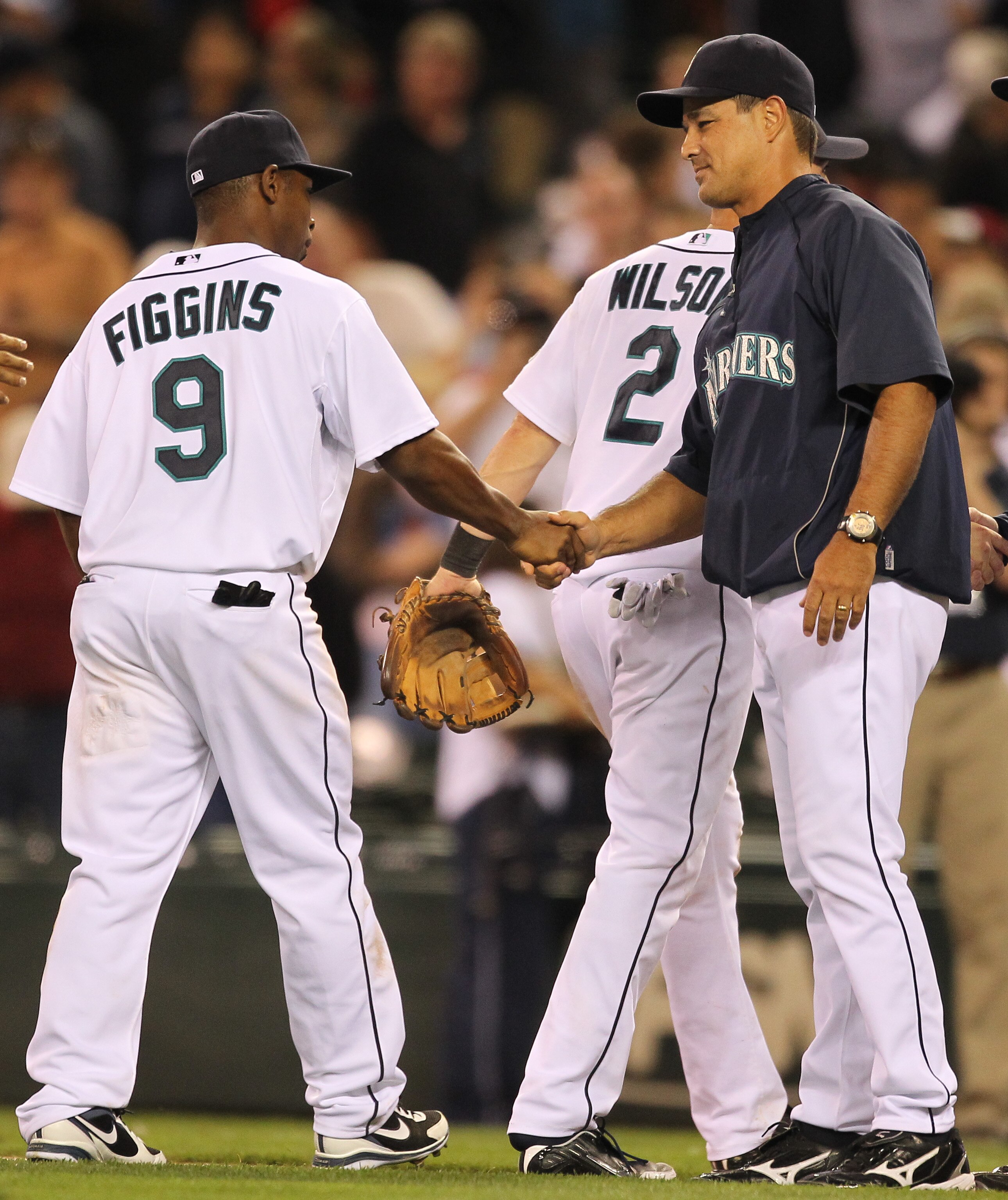 SEATTLE - AUGUST 03:  Manager Don Wakamatsu #22 of the Seattle Mariners congratulates Chone Figgins #9 after defeating the Texas Rangers 3-2 at Safeco Field on August 3, 2010 in Seattle, Washington. (Photo by Otto Greule Jr/Getty Images)