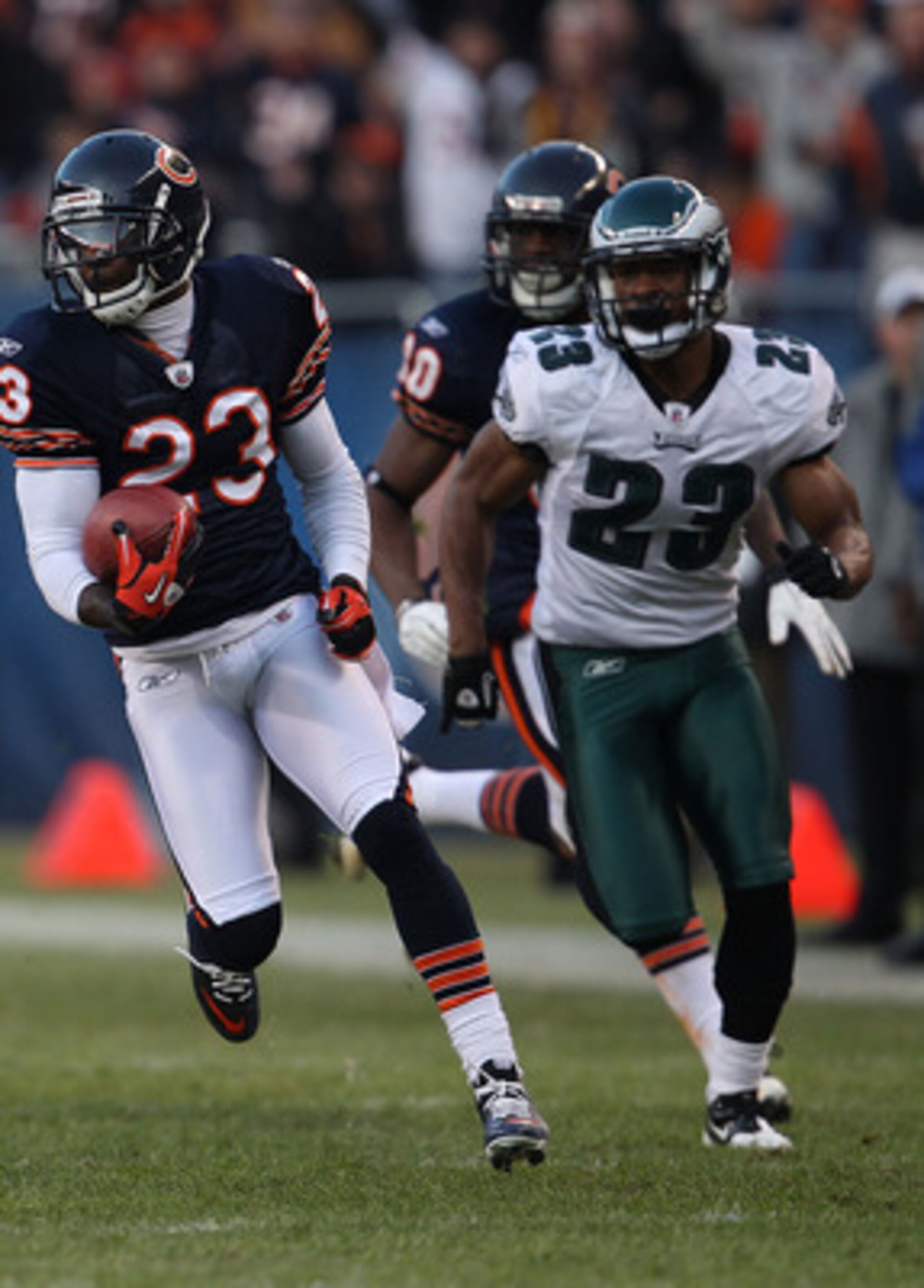 CHICAGO - NOVEMBER 28: Devin Hester #23 of the Chicago Bears breaks for a first down run of 39 yards after a catch pursued by Dimitri Patterson #23 of the Philadelphia Eagles at Soldier Field on November 28, 2010 in Chicago, Illinois. The Bears defeated t