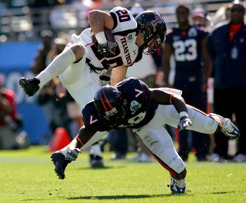 JACKSONVILLE, FL - JANUARY 01:  Danny Amendola #20 of the Texas Tech Red Raiders is tackled by  Ras-I Dowling #19 of the Virginia Cavaliers during the Gator Bowl at Jacksonville Municipal Stadium on January 1, 2008 in Jacksonville, Florida.  (Photo by Sam