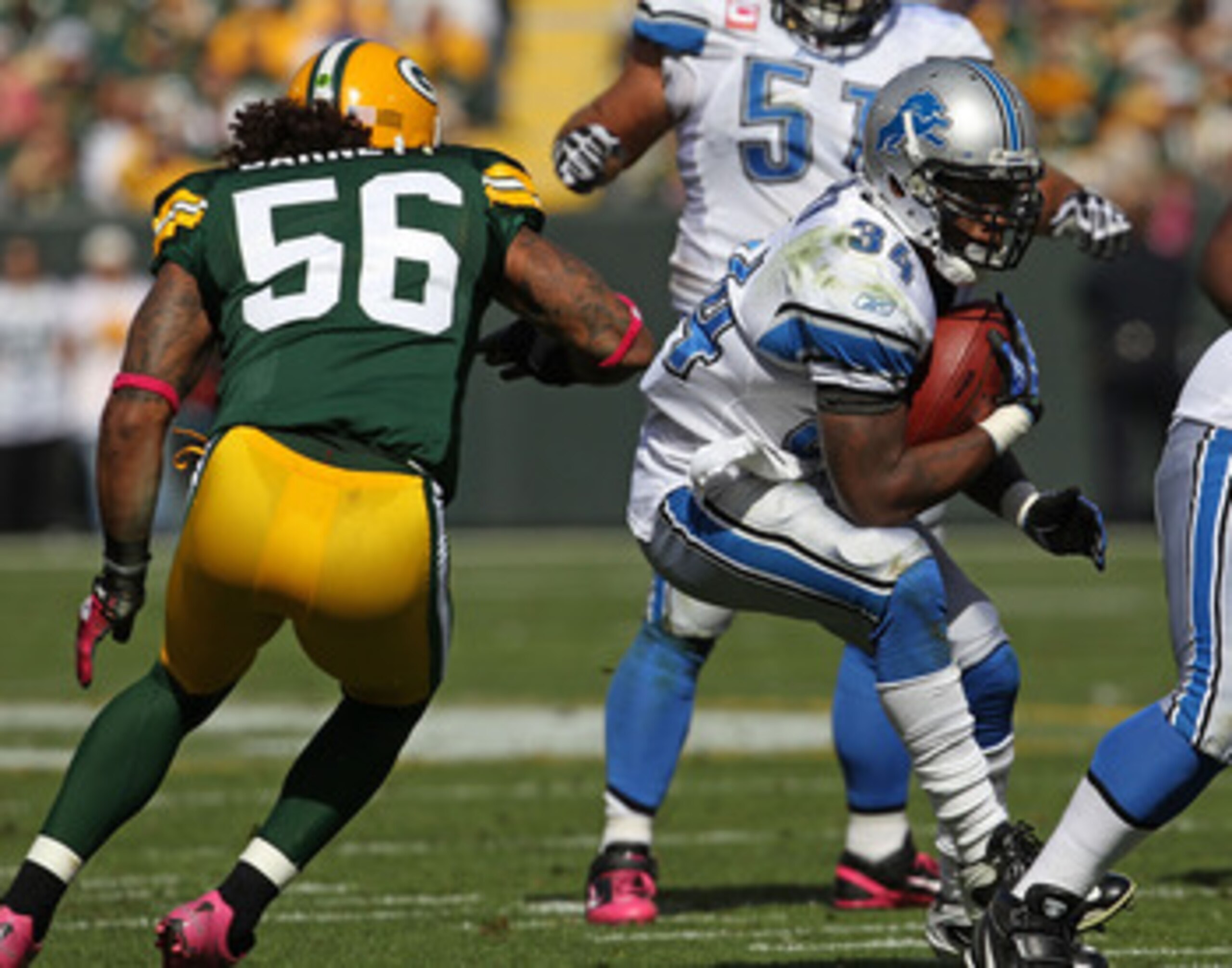 GREEN BAY, WI - OCTOBER 03: Kevin Smith #34 of the Detroit Lions tries to run past Nick Barnett #56 of the Green Bay Packers at Lambeau Field on October 3, 2010 in Green Bay, Wisconsin. The Packers defeated the Lions 28-26. (Photo by Jonathan Daniel/Getty