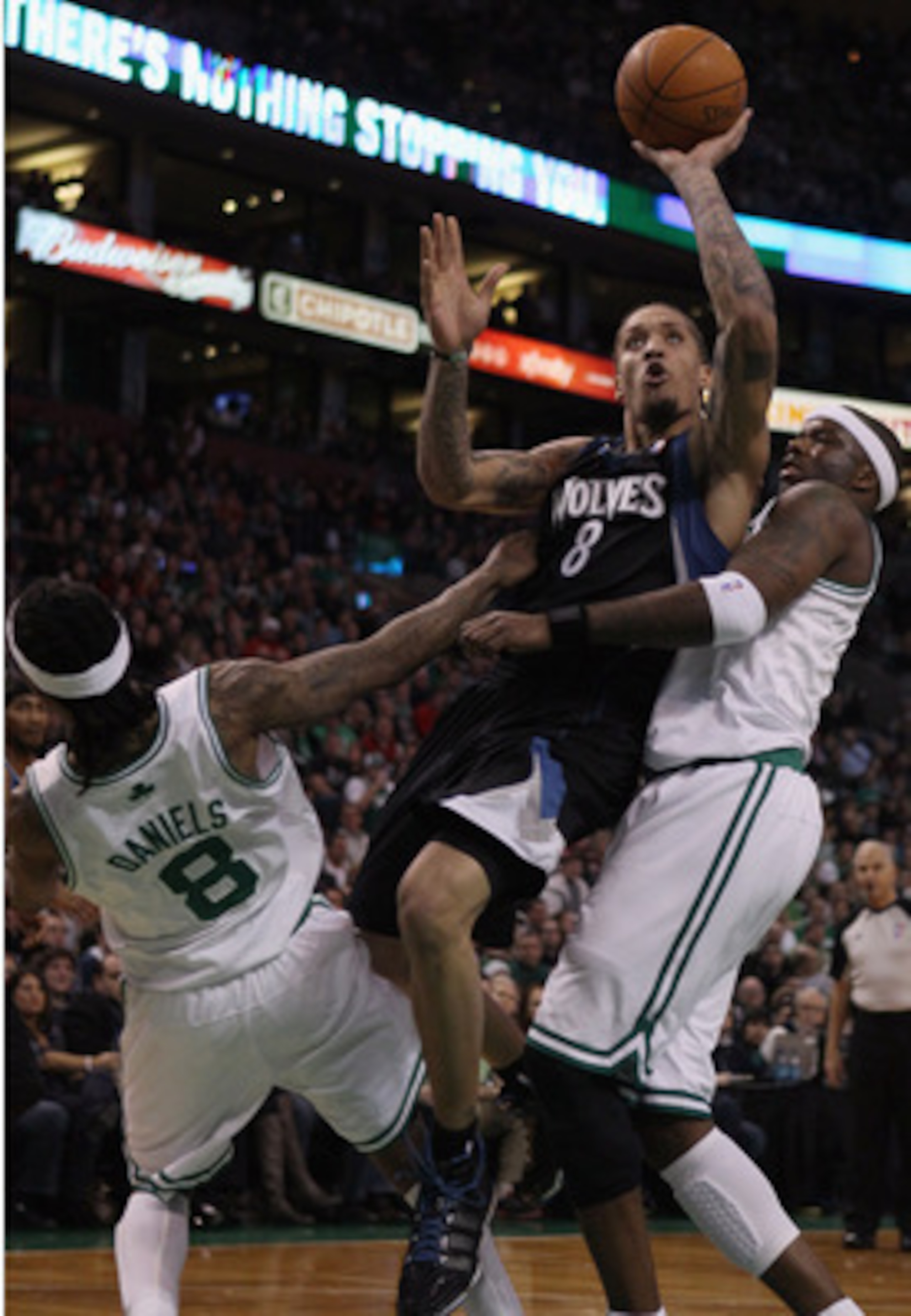 BOSTON, MA - JANUARY 03: Michael Beasley #8 of the Minnesota Timberwolves is called for an offensive foul as he drives to the net and knocks into Marquis Daniels #8 and Jermaine O'Neal #7 of the Boston Celtics on January 3, 2011 at the TD Garden in Bosto BOSTON, MA - JANUARY 03: Michael Beasley #8 of the Minnesota Timberwolves is called for an offensive foul as he drives to the net and knocks into Marquis Daniels #8 and Jermaine O'Neal #7 of the Boston Celtics on January 3, 2011 at the TD Garden in Bosto