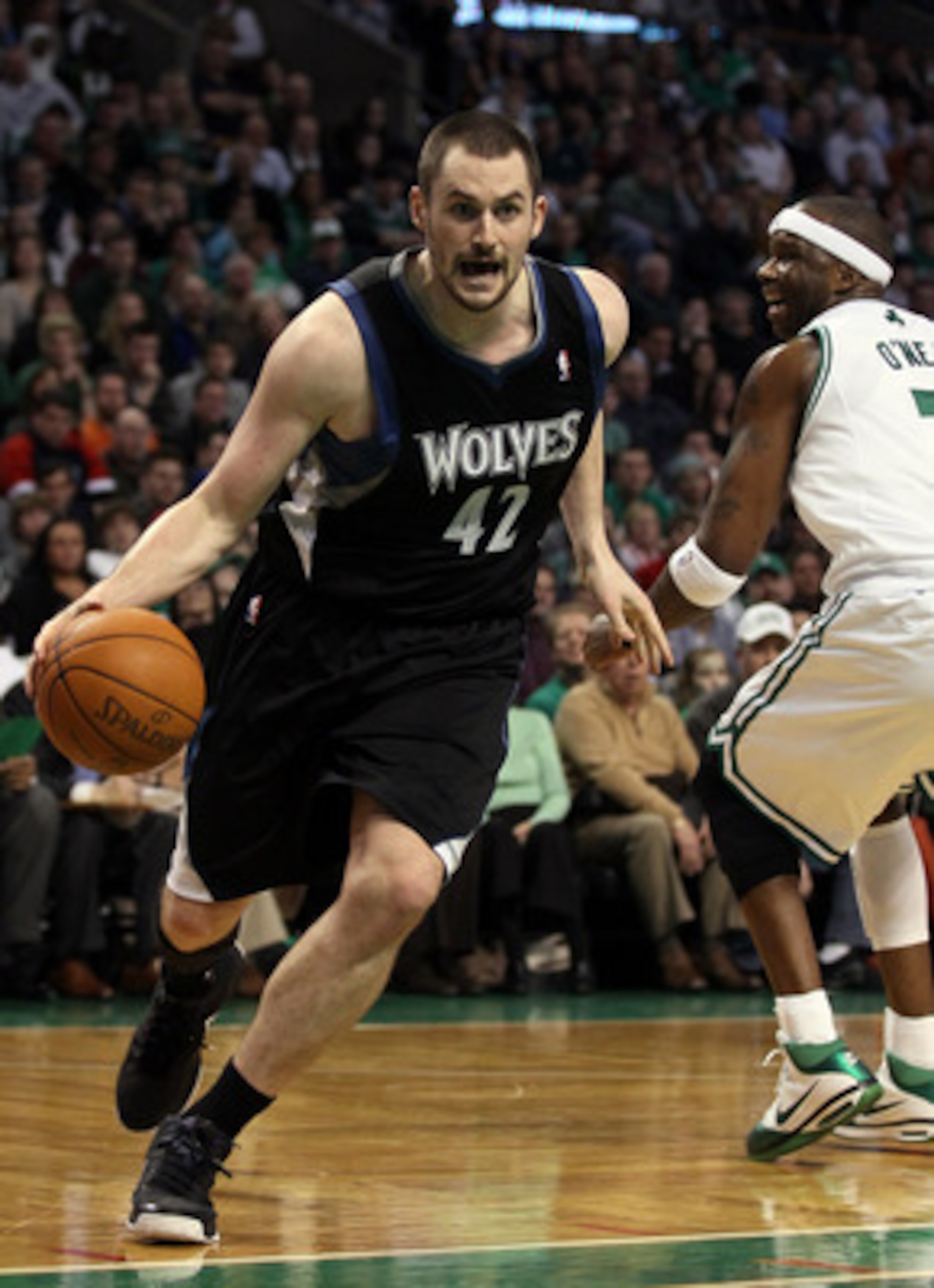 BOSTON, MA - JANUARY 03: Kevin Love #42 of the Minnesota Timberwolves drives around Jermaine O'Neal #7 of the Boston Celtics on January 3, 2011 at the TD Garden in Boston, Massachusetts. The Celtics defeated the Timberwolves 96-93. NOTE TO USER: User exp BOSTON, MA - JANUARY 03: Kevin Love #42 of the Minnesota Timberwolves drives around Jermaine O'Neal #7 of the Boston Celtics on January 3, 2011 at the TD Garden in Boston, Massachusetts. The Celtics defeated the Timberwolves 96-93. NOTE TO USER: User exp