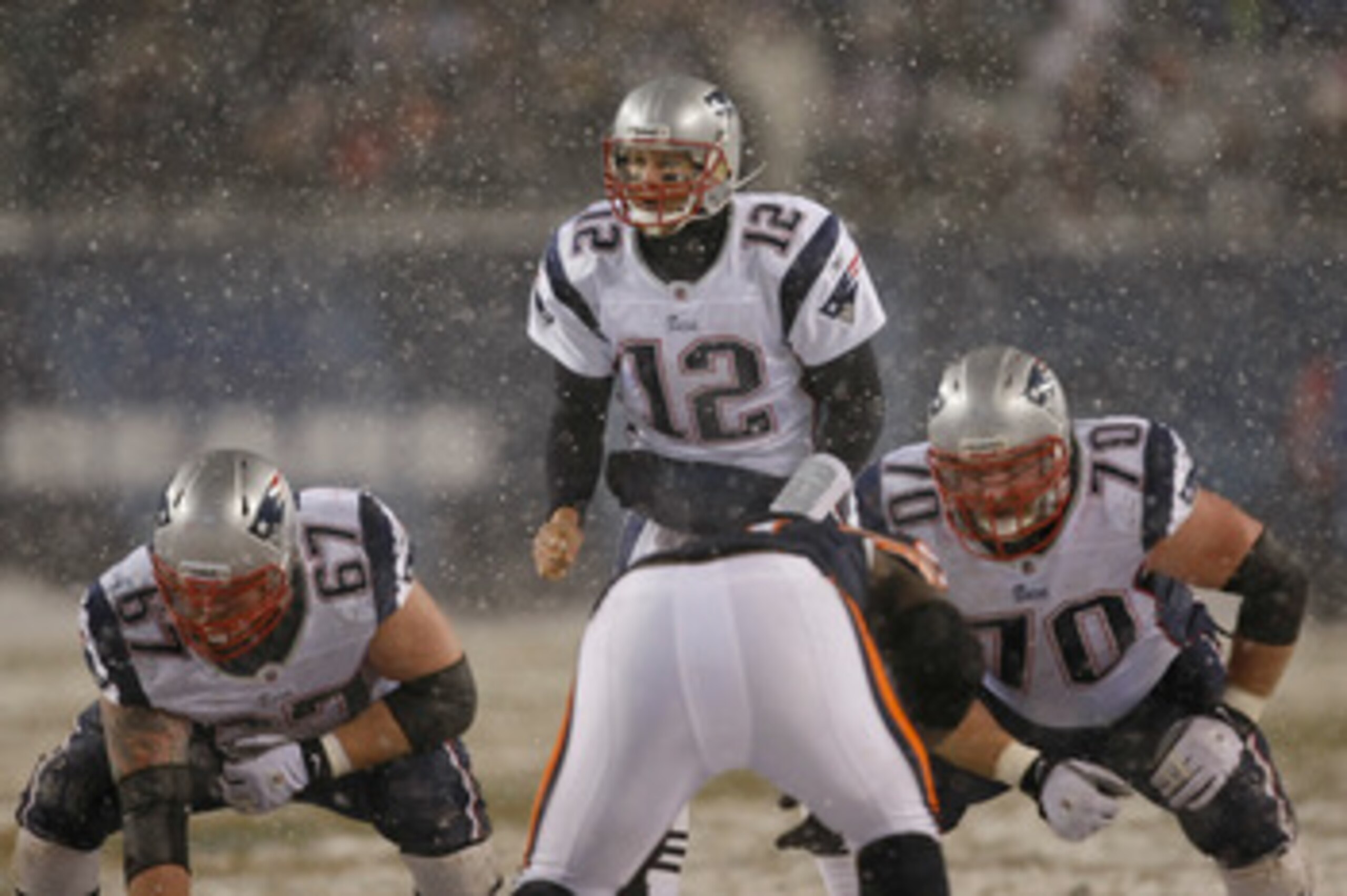 CHICAGO, IL - DECEMBER 12: Tom Brady #12 of the New England Patriots calls out signals as Dan Koppen #67 and Logan Mankins #70 awaits the snap against the Chicago Bears at Soldier Field on December 12, 2010 in Chicago, Illinois. The Patriots defeated the 