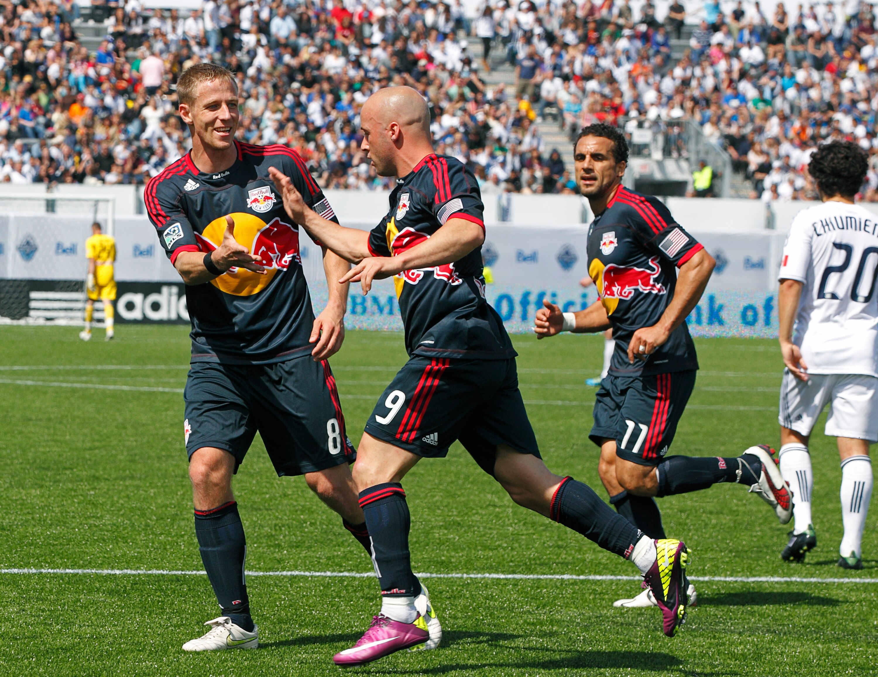 VANCOUVER, CANADA - MAY 28:  Goal scorer Luke Rodgers #9 of the New York Red Bulls is congratulated by Jan Gunnar Solli #8 and Dwayne De Rosario #11while Davide Chiumiento #20 of the Vancouver Whitecaps FC turns away during their MLS match  May 28, 2011 i