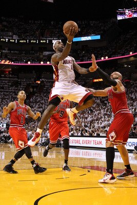 MIAMI, FL - MAY 22:  LeBron James #6 of the Miami Heat drives for a shot attempt against Carlos Boozer #5 and Derrick Rose #1 of the Chicago Bulls in Game Three of the Eastern Conference Finals during the 2011 NBA Playoffs on May 22, 2011 at American Airl