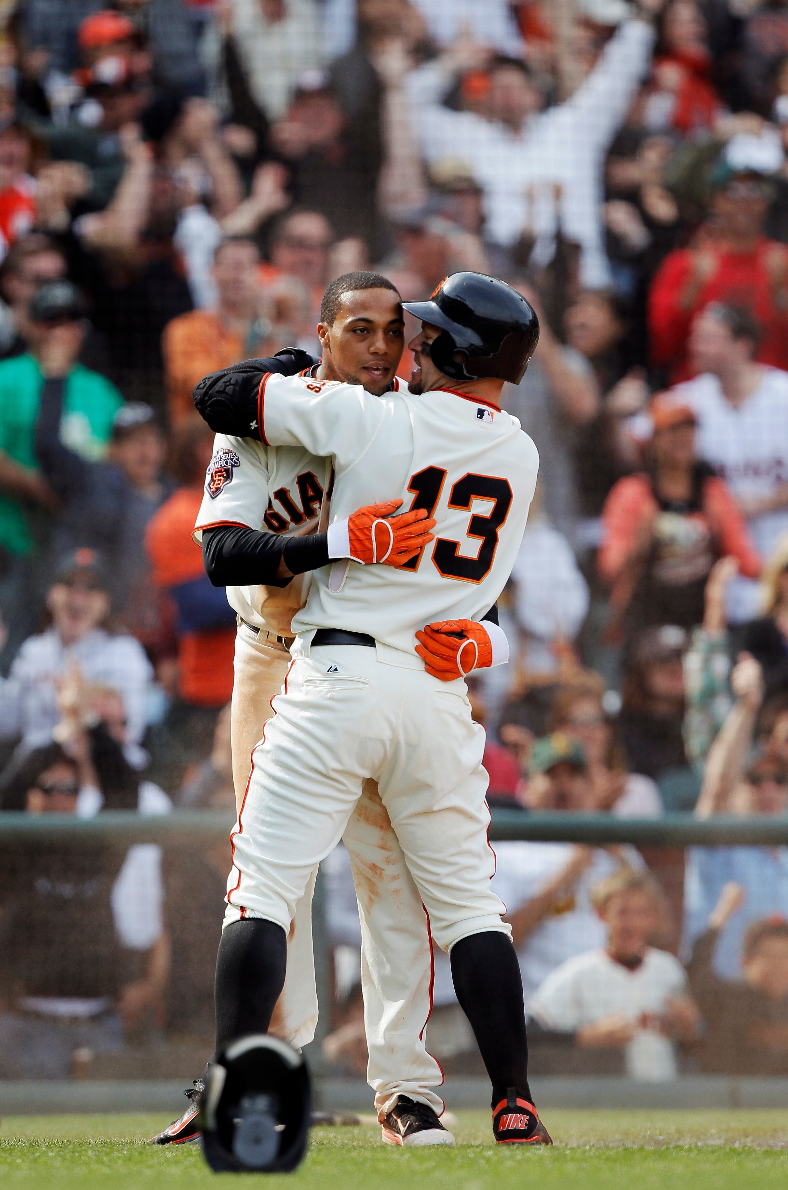SAN FRANCISCO, CA - MAY 22:  Darren Ford #34 of the San Francisco Giants gets hugged by Cody Ross #13 after scoring the winning run on a single by Emmanuel Buriss against the Oakland A's in the 11th inning at AT&T Park on May 22, 2011 in San Francisco, Ca