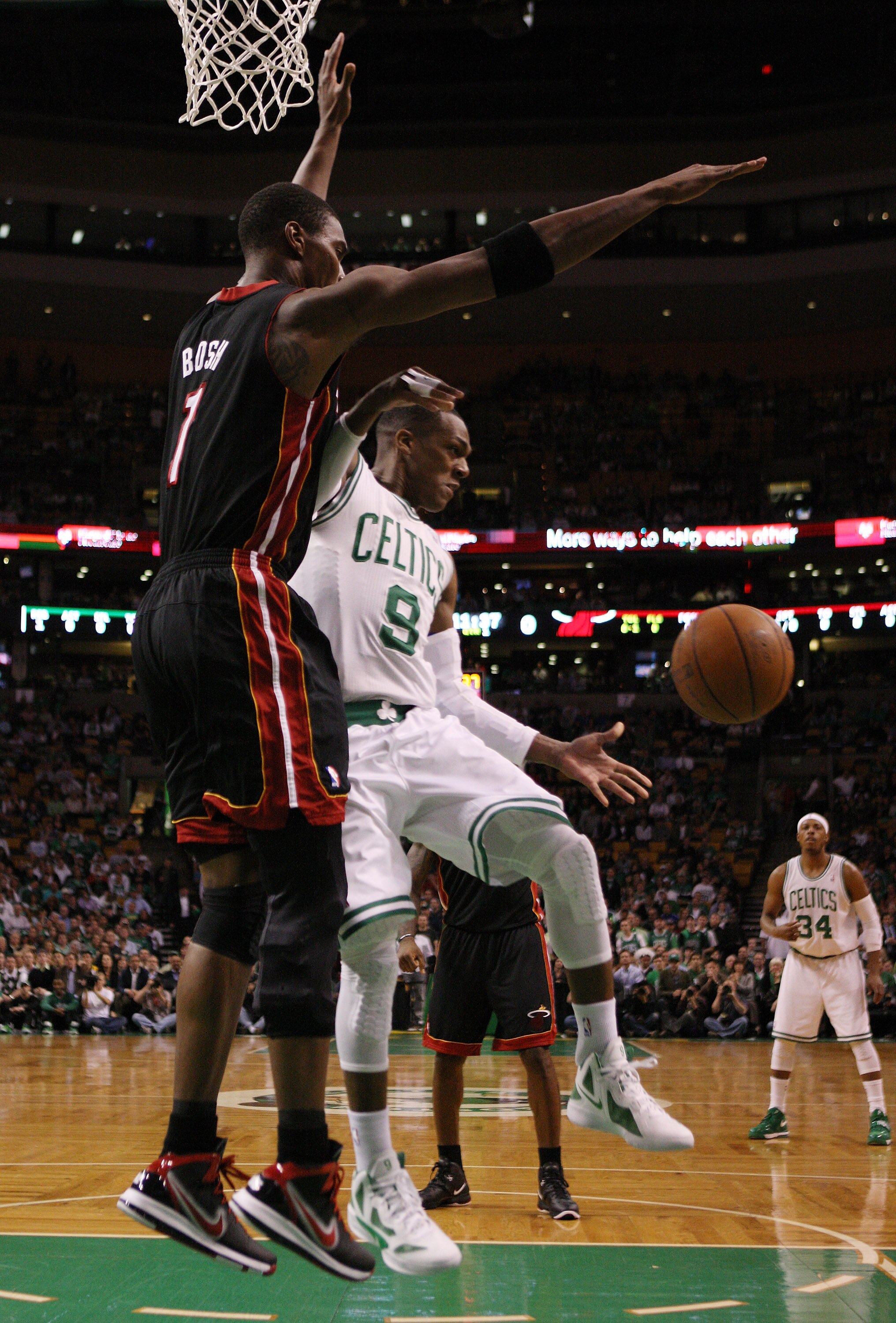 BOSTON, MA - MAY 09:  Rajon Rondo #9 of the Boston Celtics passes the ball as Chris Bosh #1 of the Miami Heat defends in Game Four of the Eastern Conference Semifinals in the 2011 NBA Playoffs on May 9, 2011 at the TD Garden in Boston, Massachusetts.  NOT