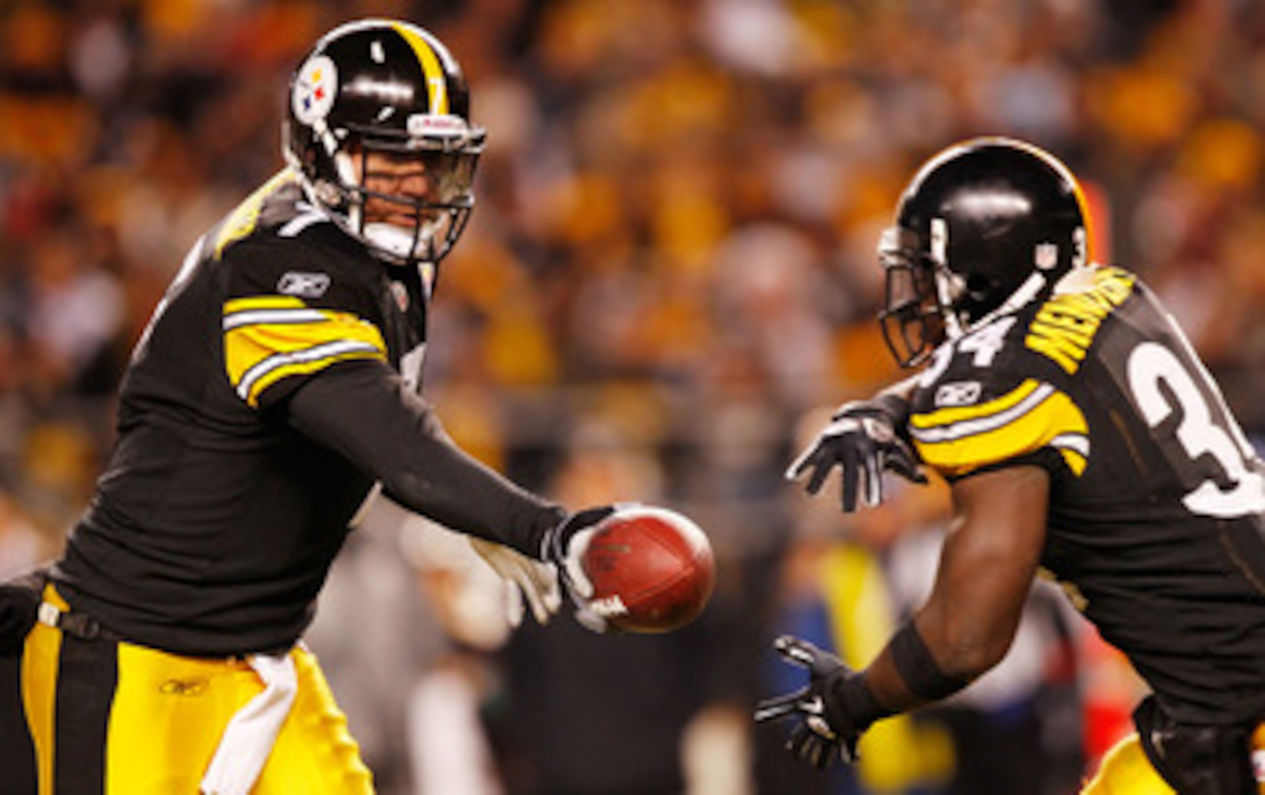 PITTSBURGH - DECEMBER 23:  Ben Roethlisberger #7 of the Pittsburgh Steelers hands the ball off to teammate Rashard Mendenhall #34 during the game against  the Carolina Panthers on December 23, 2010 at Heinz Field in Pittsburgh, Pennsylvania.  (Photo by Ja