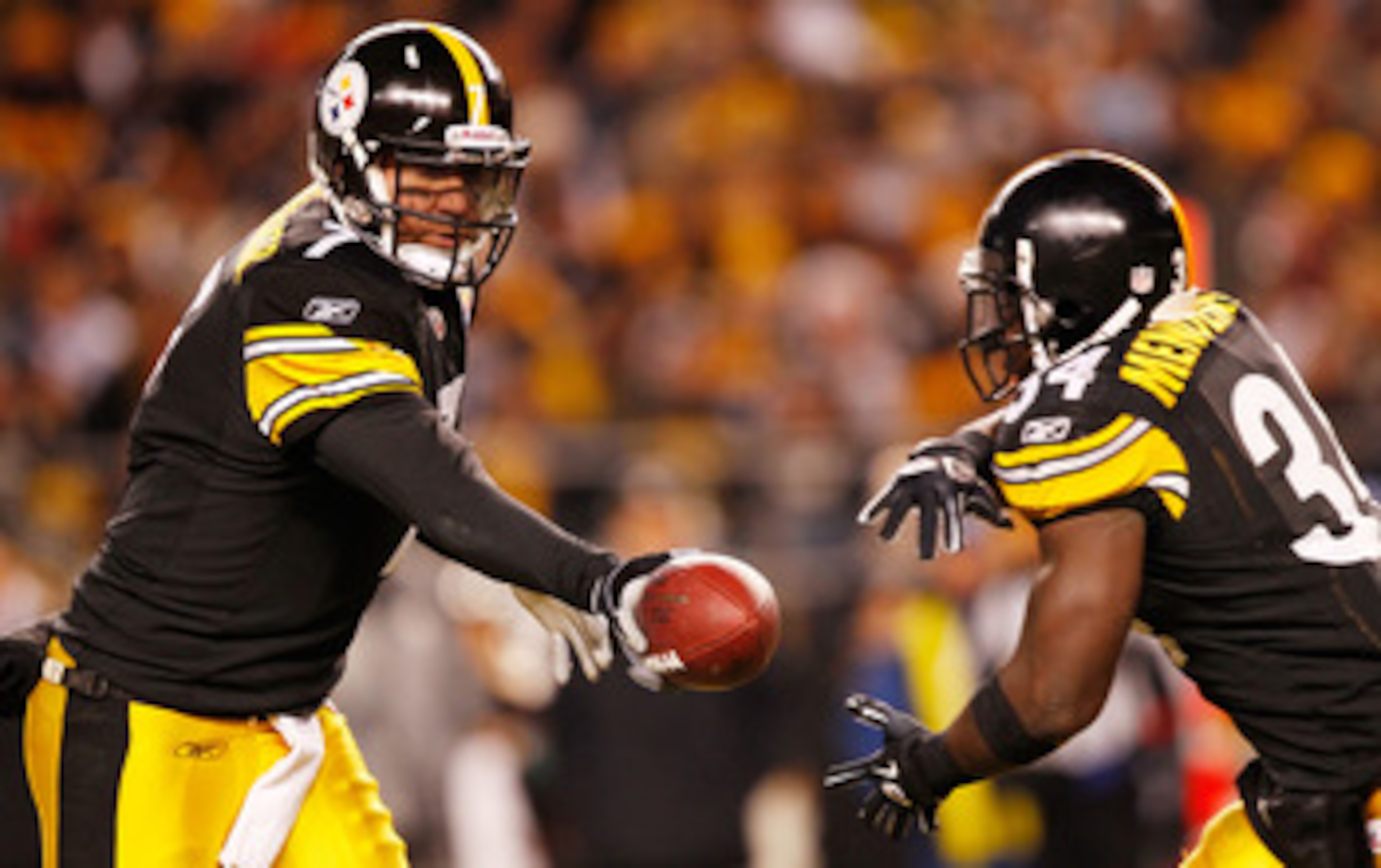 PITTSBURGH - DECEMBER 23:  Ben Roethlisberger #7 of the Pittsburgh Steelers hands the ball off to teammate Rashard Mendenhall #34 during the game against  the Carolina Panthers on December 23, 2010 at Heinz Field in Pittsburgh, Pennsylvania.  (Photo by Ja
