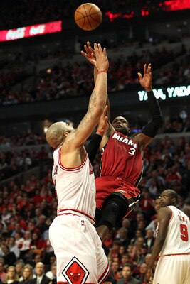 CHICAGO, IL - MAY 26:  Dwyane Wade #3 of the Miami Heat attempts a shot against Carlos Boozer #5 of the Chicago Bulls in Game Five of the Eastern Conference Finals during the 2011 NBA Playoffs on May 26, 2011 at the United Center in Chicago, Illinois. NOT