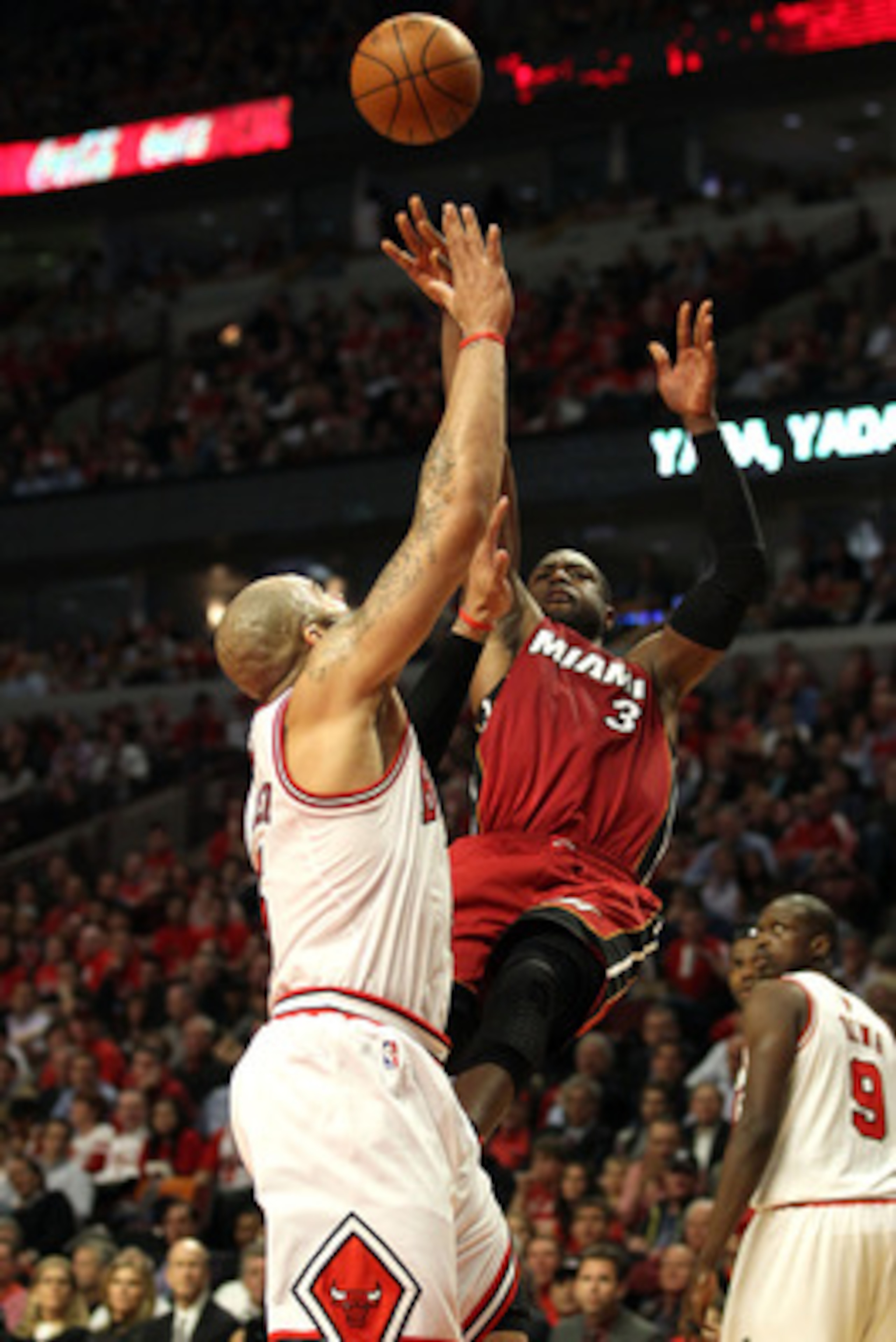 CHICAGO, IL - MAY 26:  Dwyane Wade #3 of the Miami Heat attempts a shot against Carlos Boozer #5 of the Chicago Bulls in Game Five of the Eastern Conference Finals during the 2011 NBA Playoffs on May 26, 2011 at the United Center in Chicago, Illinois. NOT