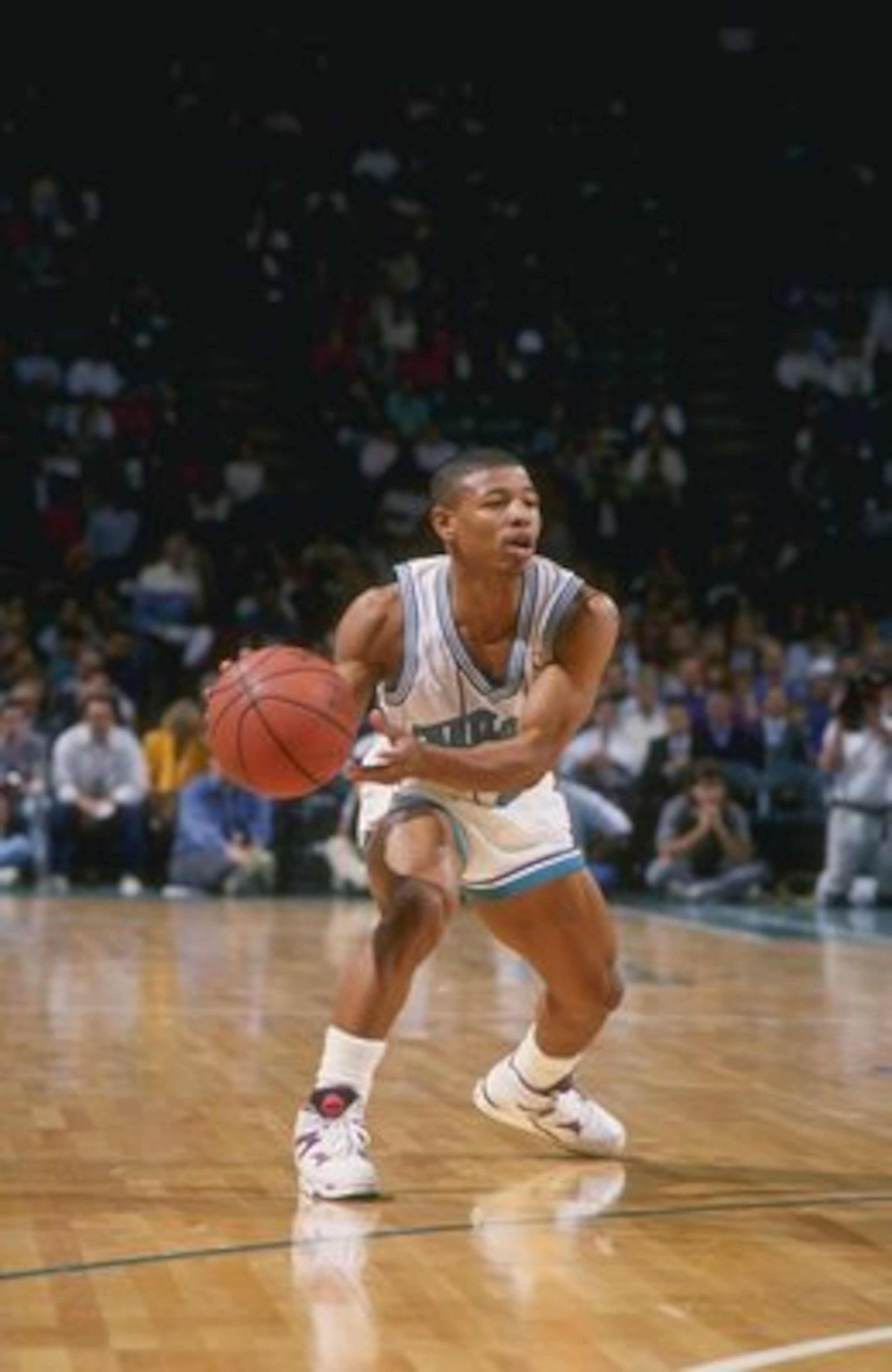 1990:  Guard Tyrone (Muggsy) Bogues of the Charlotte Hornets in action with the ball during a game at the Charlotte Coliseum in Charlotte, North Carolina. Mandatory Credit: Stephen Dunn  /Allsport