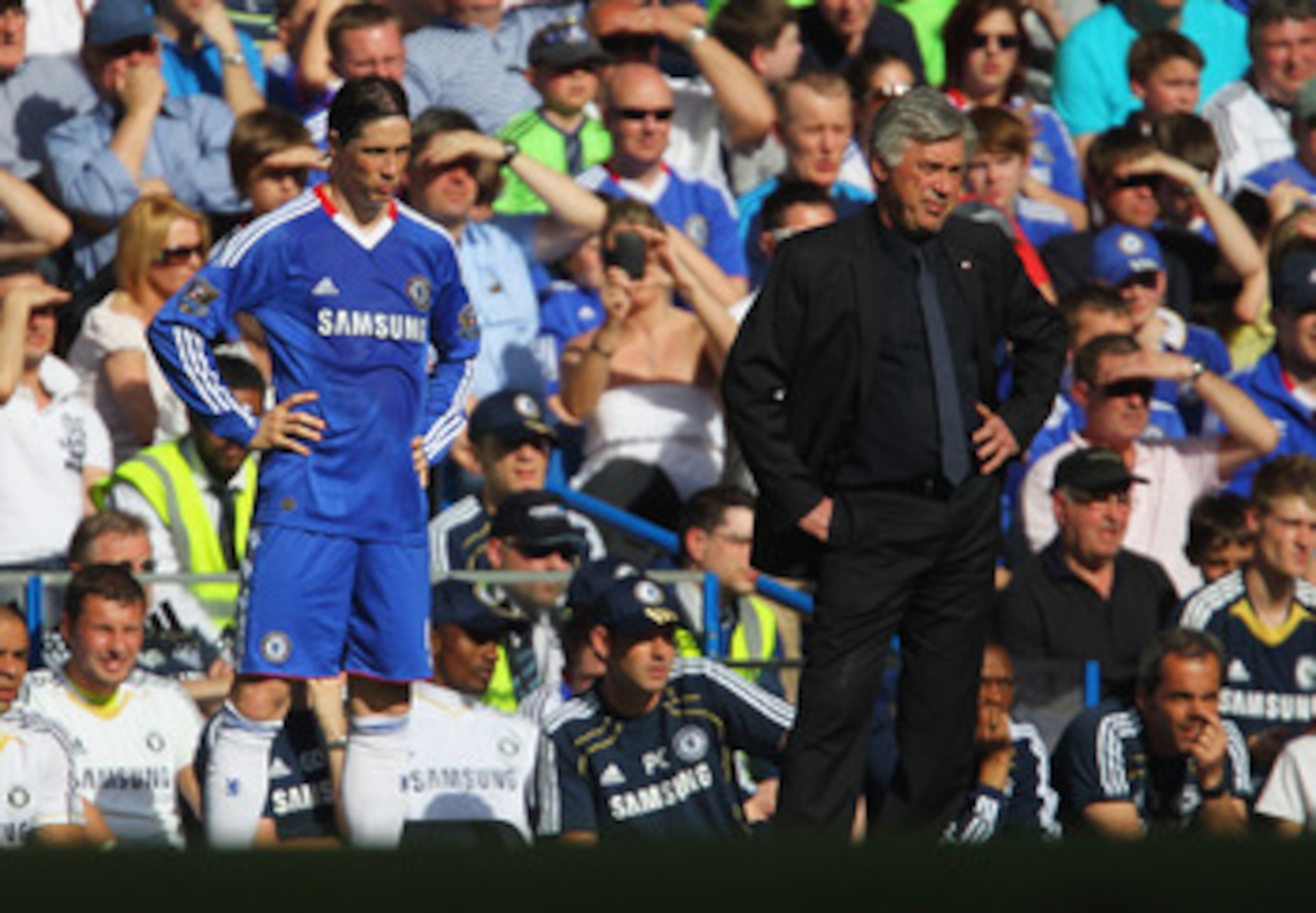 LONDON, ENGLAND - APRIL 09:  Carlo Ancelotti manager of Chelsea and substitute Fernado Torres look on from the touchline during the Barclays Premier League match between Chelsea and Wigan Athletic at Stamford Bridge on April 9, 2011 in London, England.  (