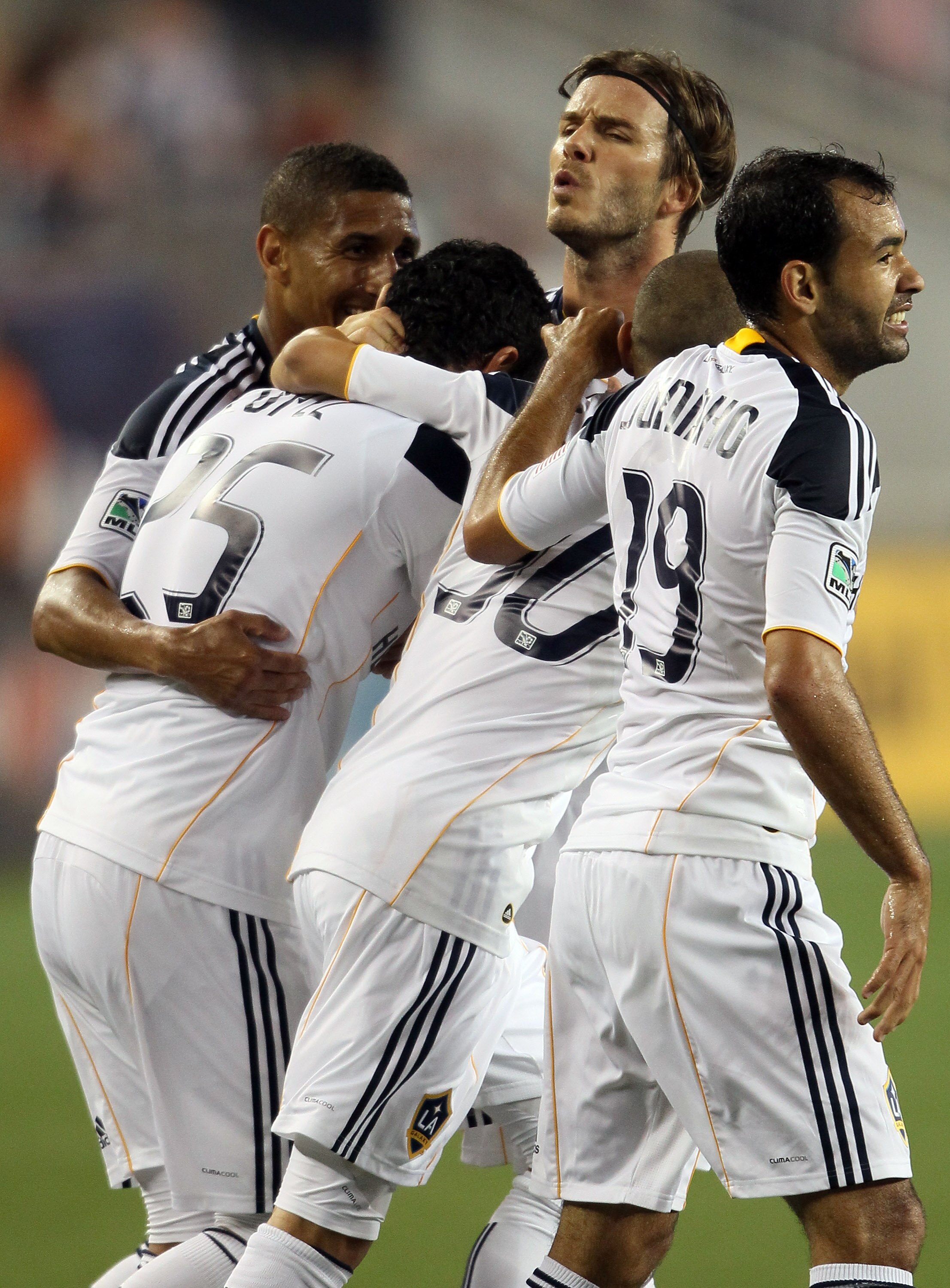 FOXBORO, MA - MAY 28:  Miguel Lopez #25 of the Los Angeles Galaxy is congratulated by teammates David Beckham #23, Juninho #19 and Paolo Cardozo #30 after Lopez scored the game winning goal in the second half against the New England Revolution on May 28,